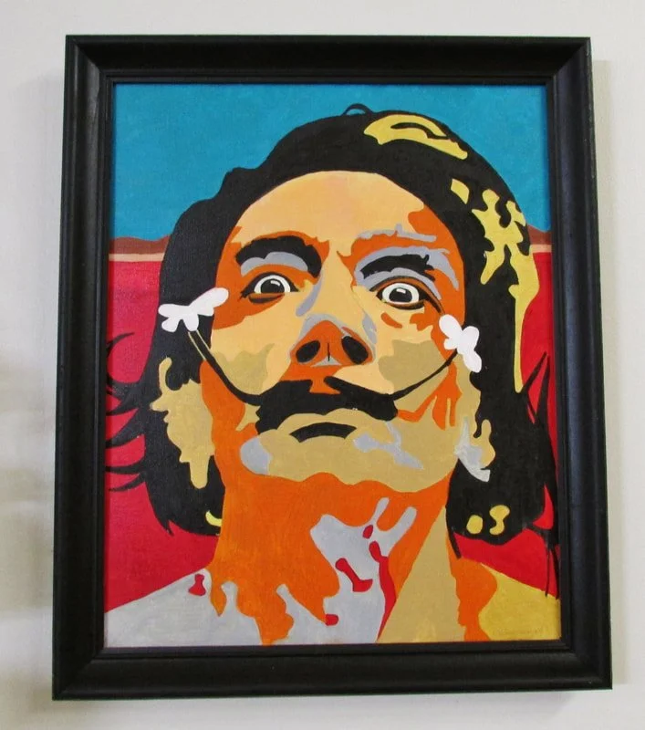 Colorful portrait of a man with long hair, mustache, and beard, wearing a headset with microphones. The background is split with blue on the top and red on the bottom.