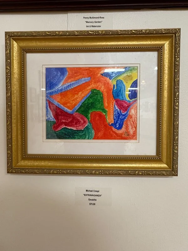 Colorful abstract watercolor painting with bold shapes and vivid colors, framed in an ornate gold frame.