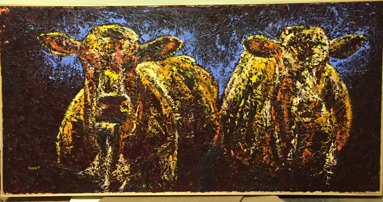 An abstract painting of two cows with yellow, orange, and dark tones against a dark background.