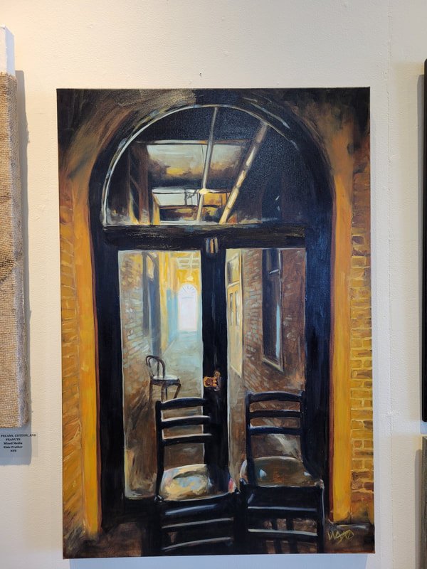 Painting of an arched doorway opening into a sunlit corridor with two black wooden chairs in front and a chair with flowers inside.