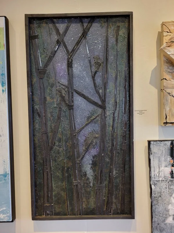 Mixed media art piece depicting tall, dark, textured trees with a starry night background.