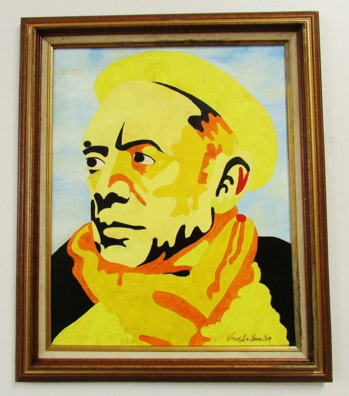 A framed painting of a man, stylized in bold blocks of yellow, orange, black, and white, with prominent facial features and a scarf.