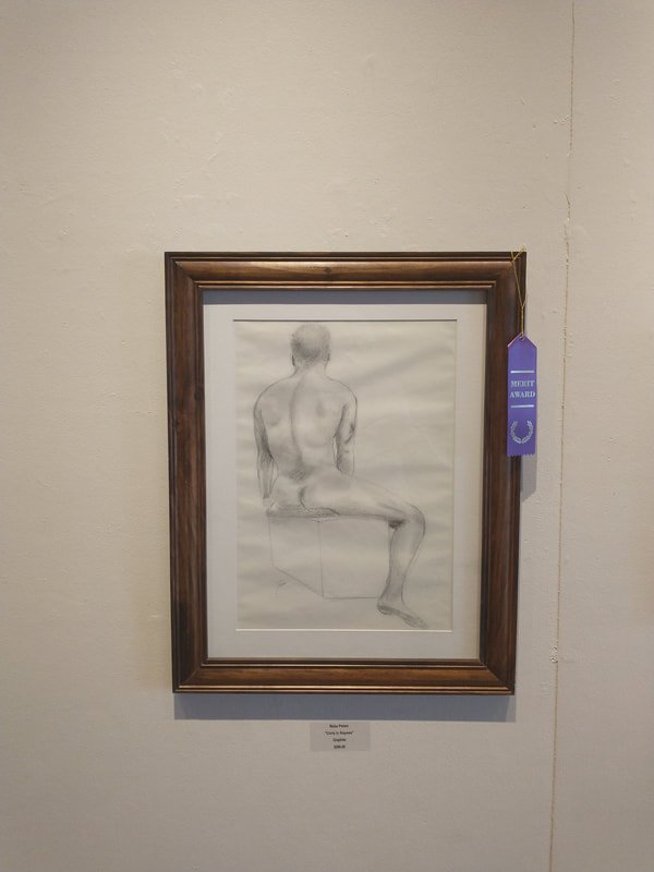 A framed pencil sketch of a seated, shirtless man viewed from the back, displayed on a white wall with a purple award ribbon hanging beside it.