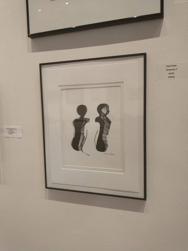 Black and white artwork of two abstract female side profiles with different hairstyles, signed by the artist.
