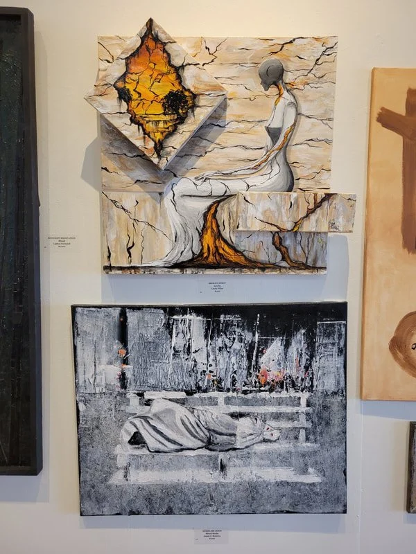 Mixed media art display featuring two artworks. The top artwork shows a serene figure in white robes with a bald head sitting with eyes closed, connected to a flowing waterfall that emerges from a cracked, fiery landscape inside a diamond-shaped fram