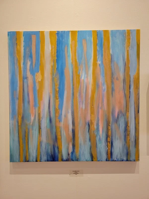 Abstract painting with vertical streaks of blue, peach, beige, and gold colors on canvas