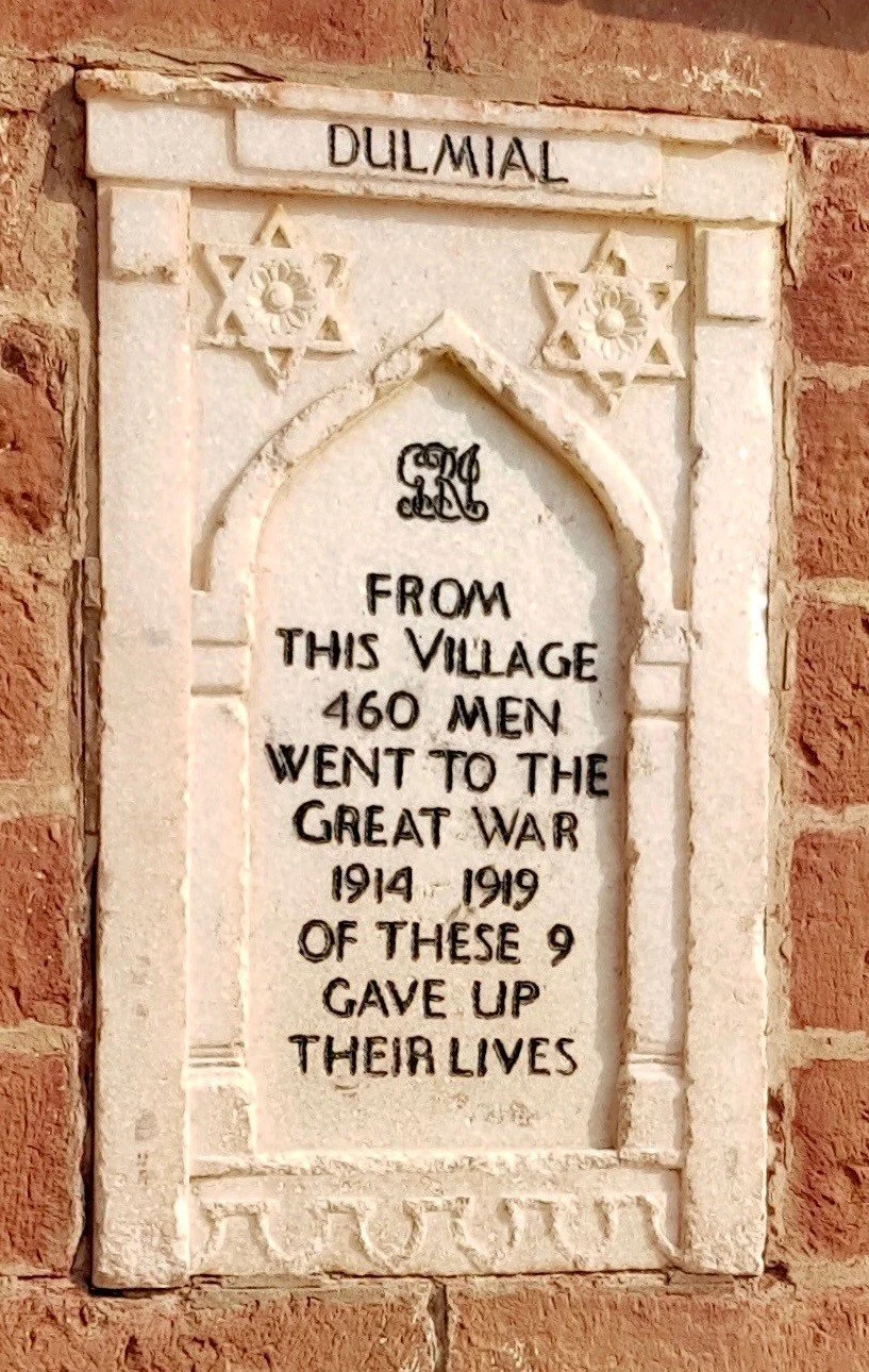 Stone memorial plaque with inscriptions honoring nine men from the village who fought in World War I from 1914 to 1919, with Star of David symbols and the name Dulmial at the top.