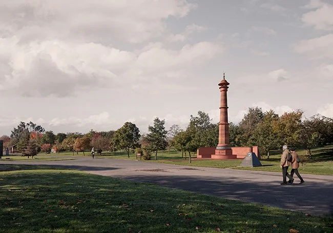 A park with a paved pathway, green grass, trees, and the propsed Muslim monument, under a partly cloudy sky, with two people walking together.