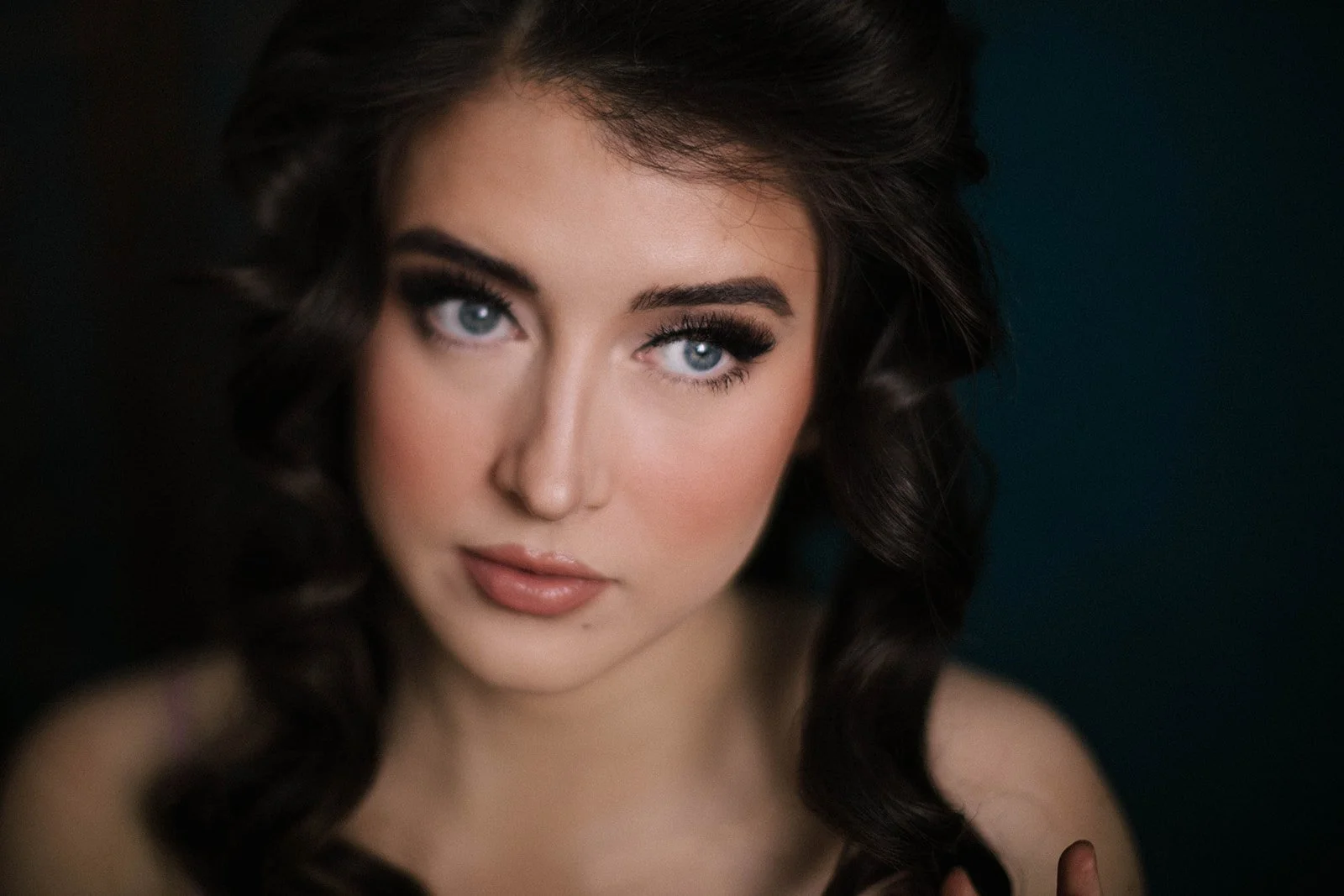 A close up image of a woman with bright blue eyes. The image is slightly blurred using a camera technique called freelensing