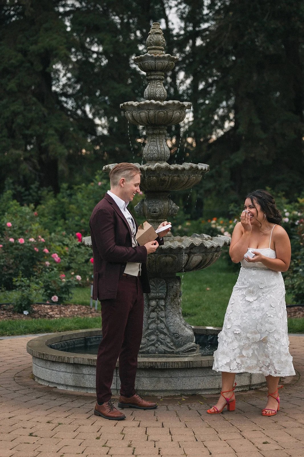 A woman gifts her fiance a silly card and laughs as he opens it