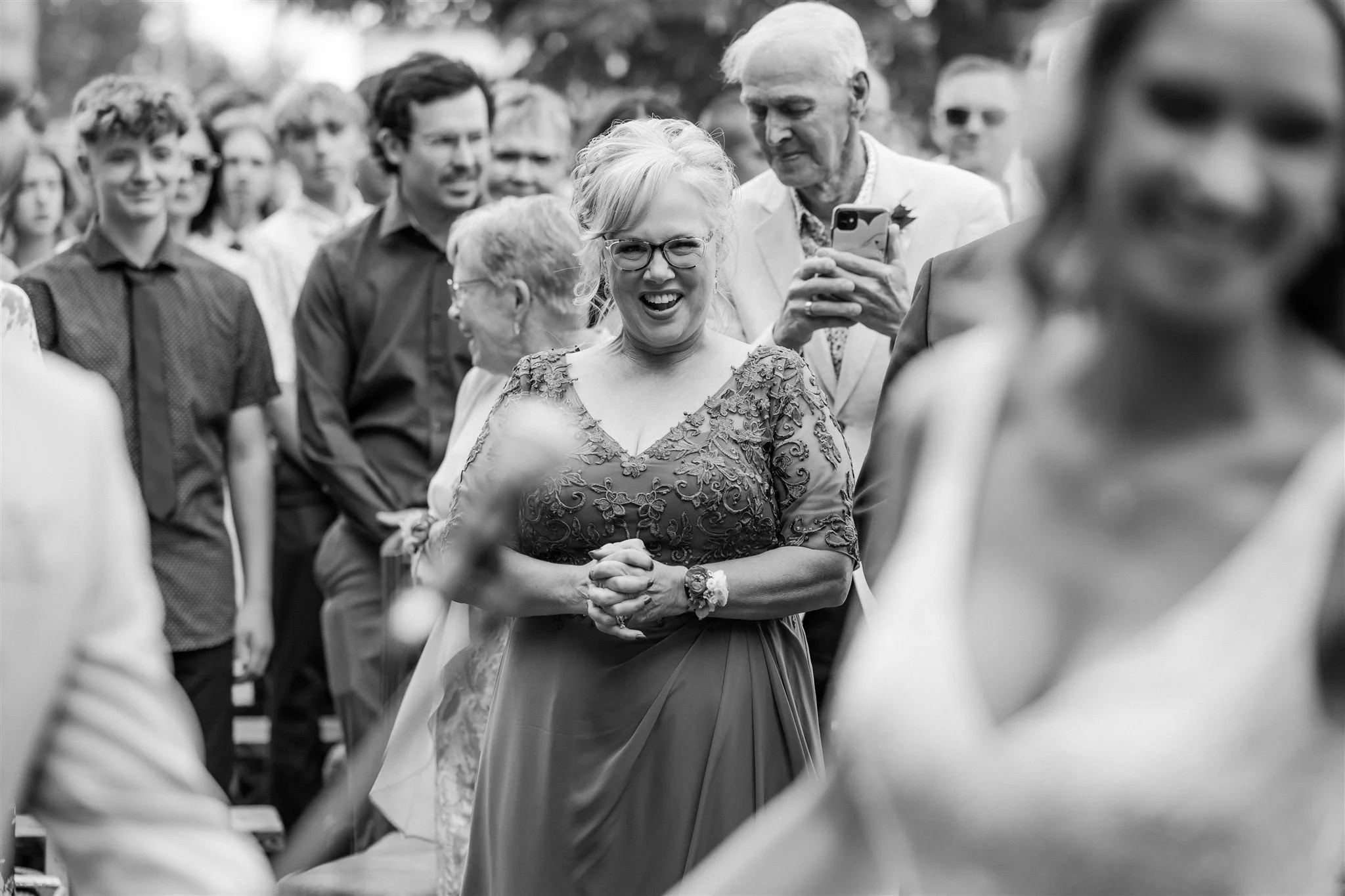 mother-of-the-bride smiling and watching her daughter-thin-bordered