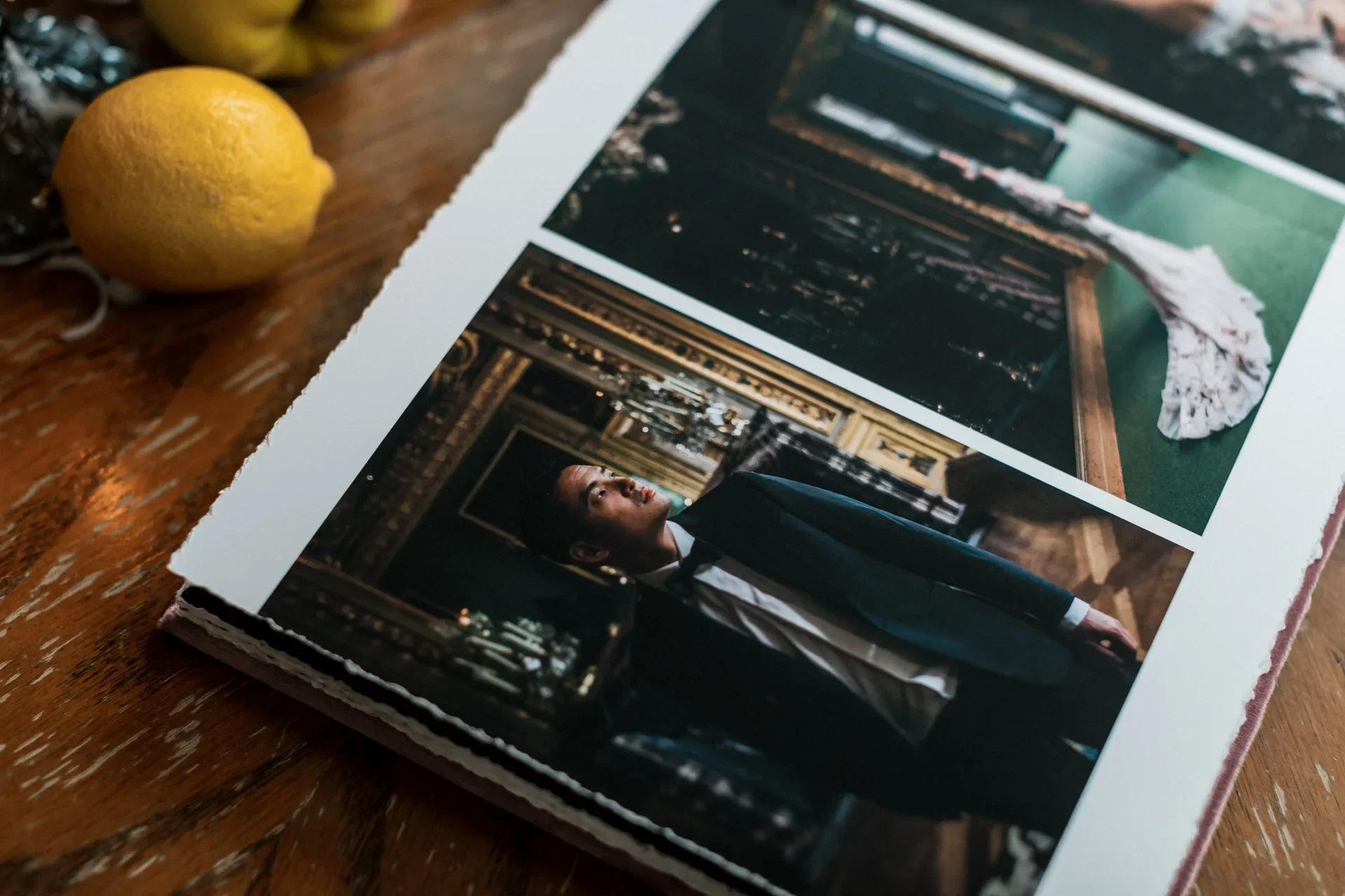 Open wedding album spread showing a groom portrait and bridal bouquet photos-thin-bordered
