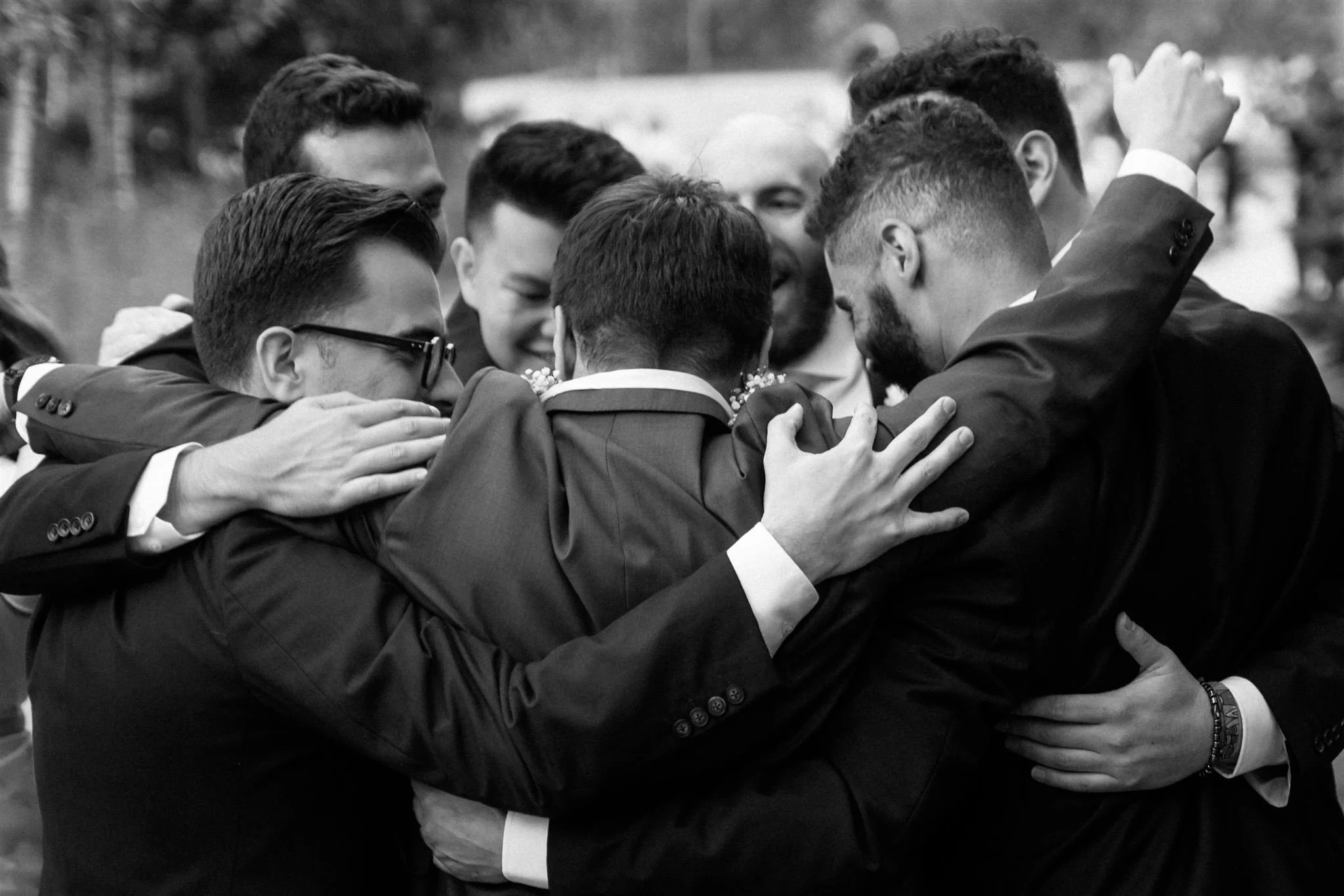 a group of groomsmen hugging-thin-bordered