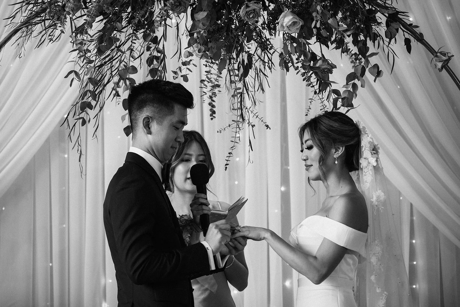 A couple exchanges rings at the altar after saying thier wedding vows