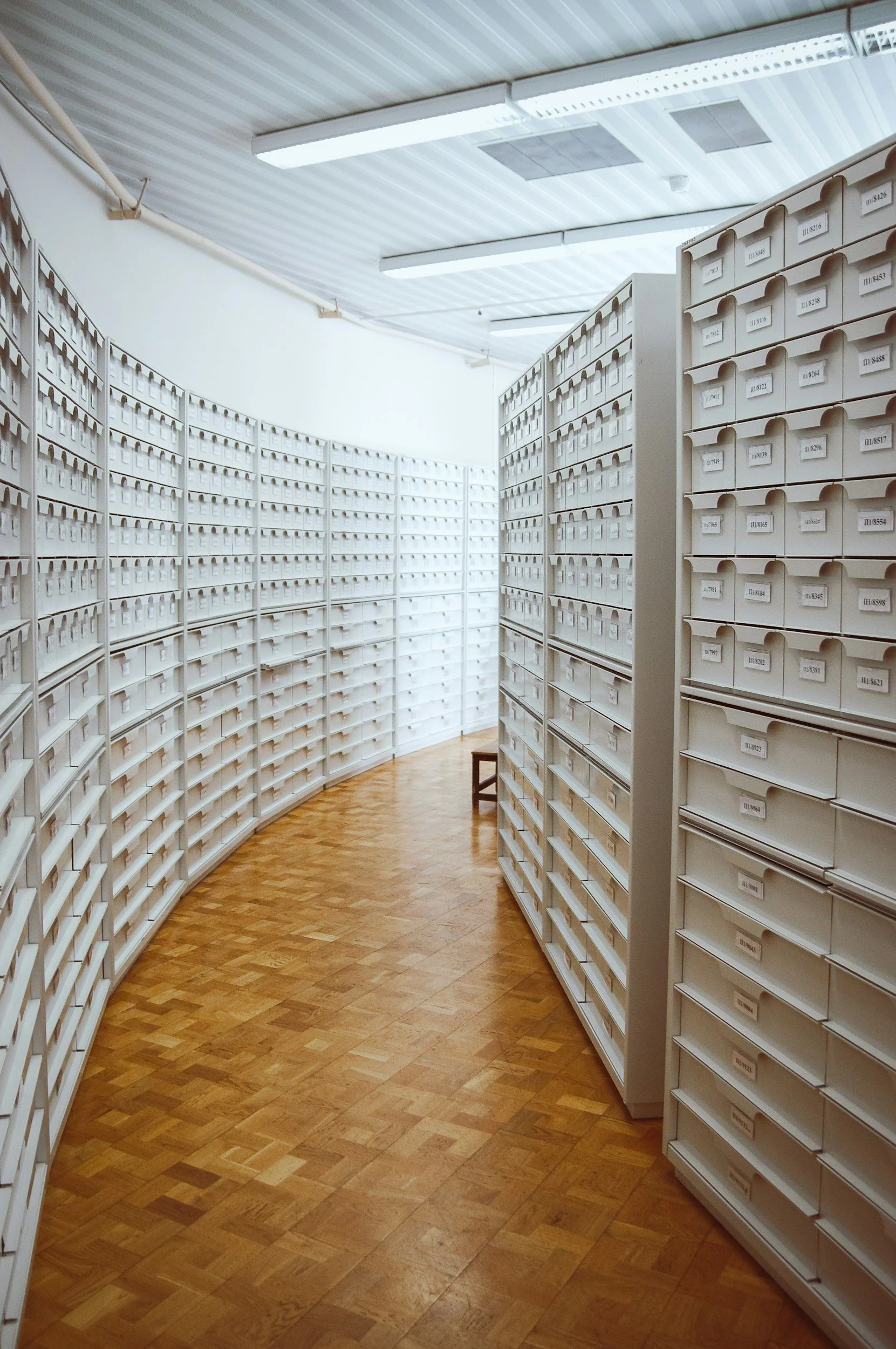 A secured room with archival shelving and drawers arranged for archival best practices for accessibility