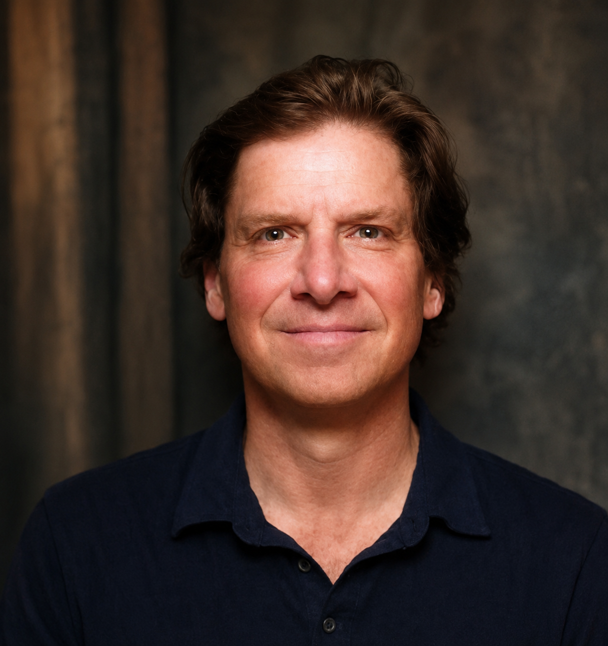 Profile picture of Muninn Archives founder and CEO, wearing a dark polo shirt, against a dark, textured background.