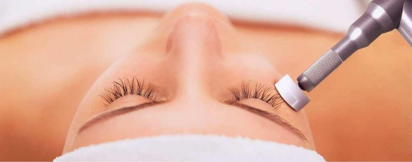 Next-Generation Needling facial treatment with precision device near the eye area, combining growth factors, LED therapy, and recovery masque to boost collagen, minimize inflammation, and reduce downtime.