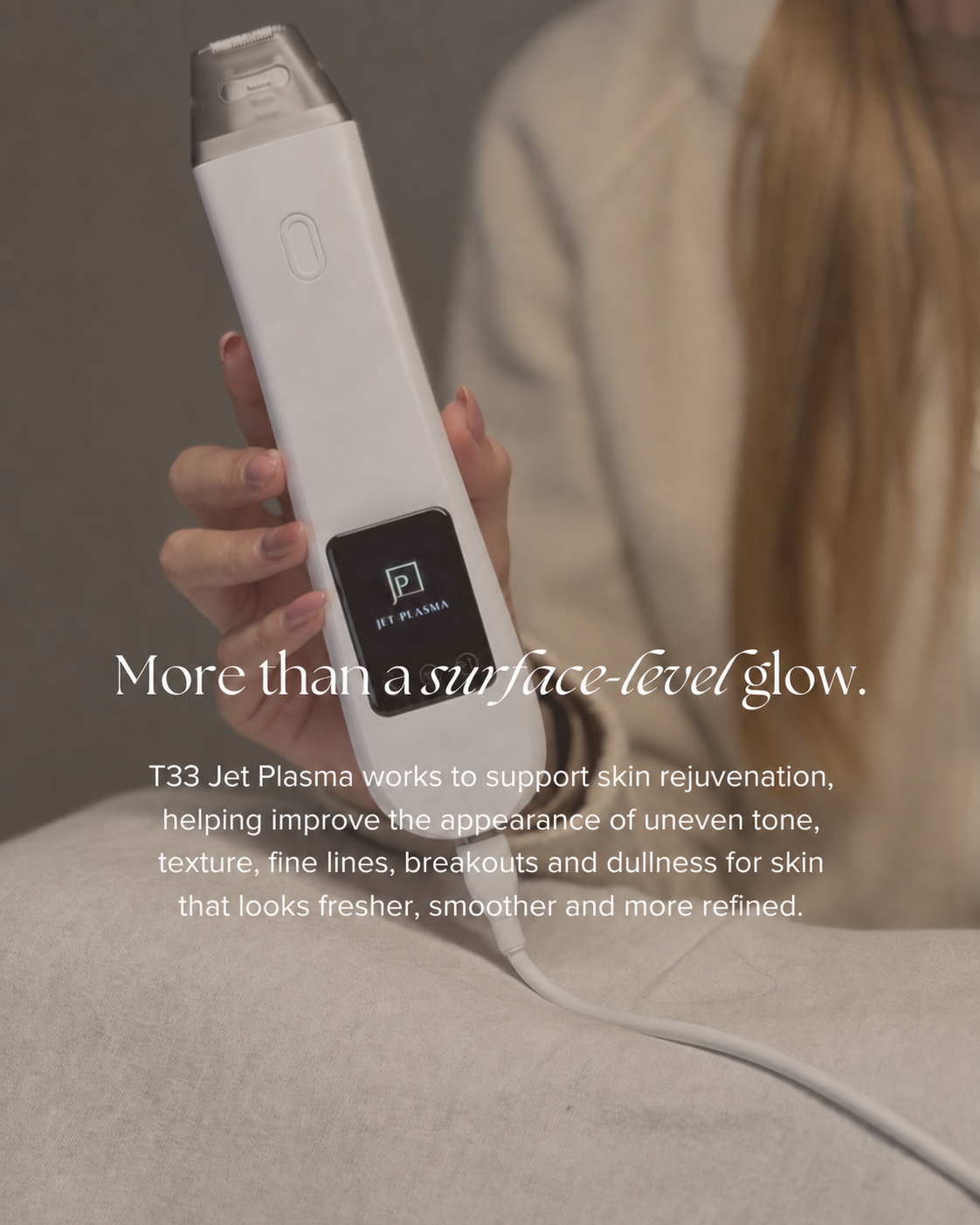 A hand holding a white portable skin rejuvenation device with a small screen showing the text 'JET PLASMA' in a professional setting.
