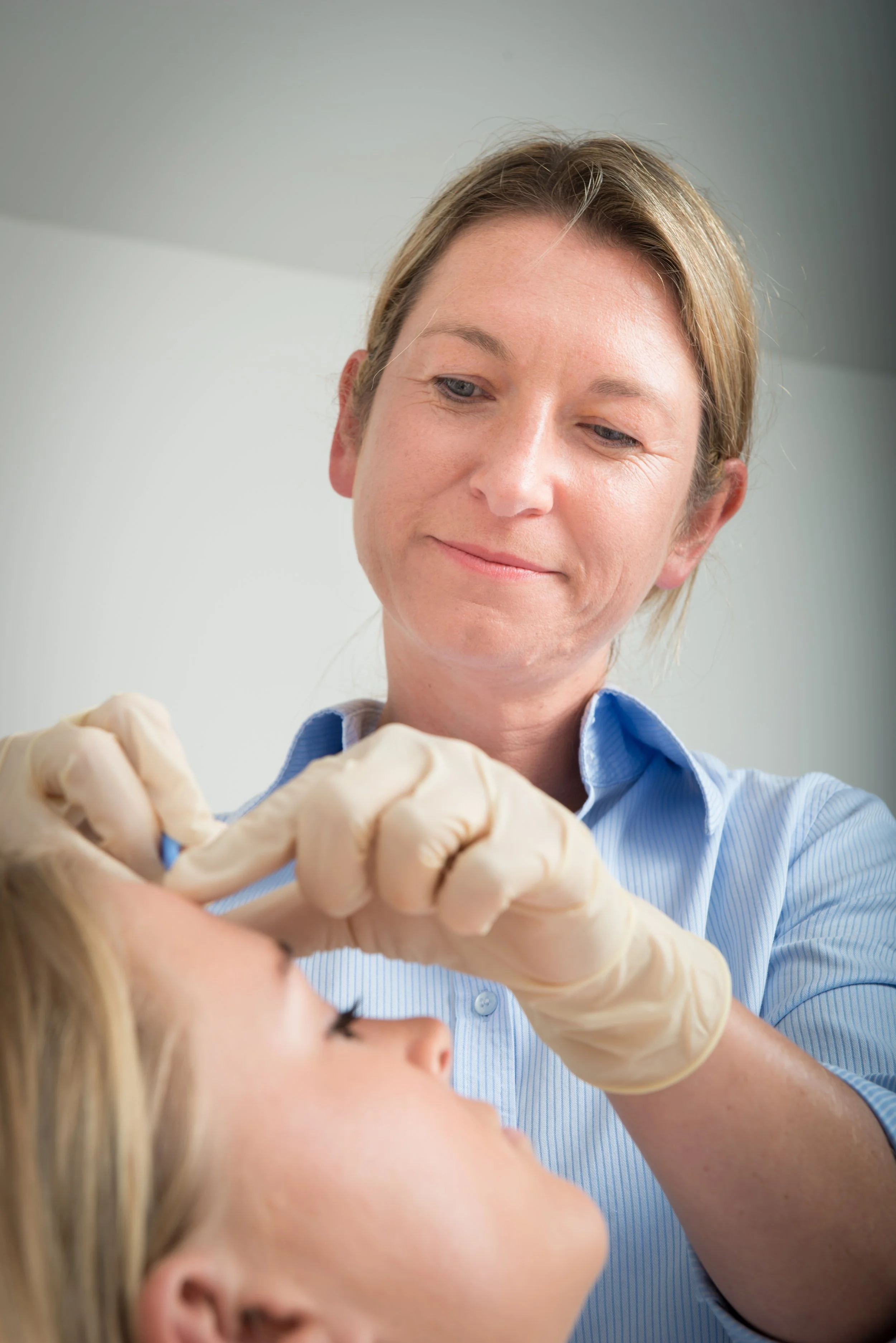Ms Helen McEvoy performing a minor cosmetic surgical procedure