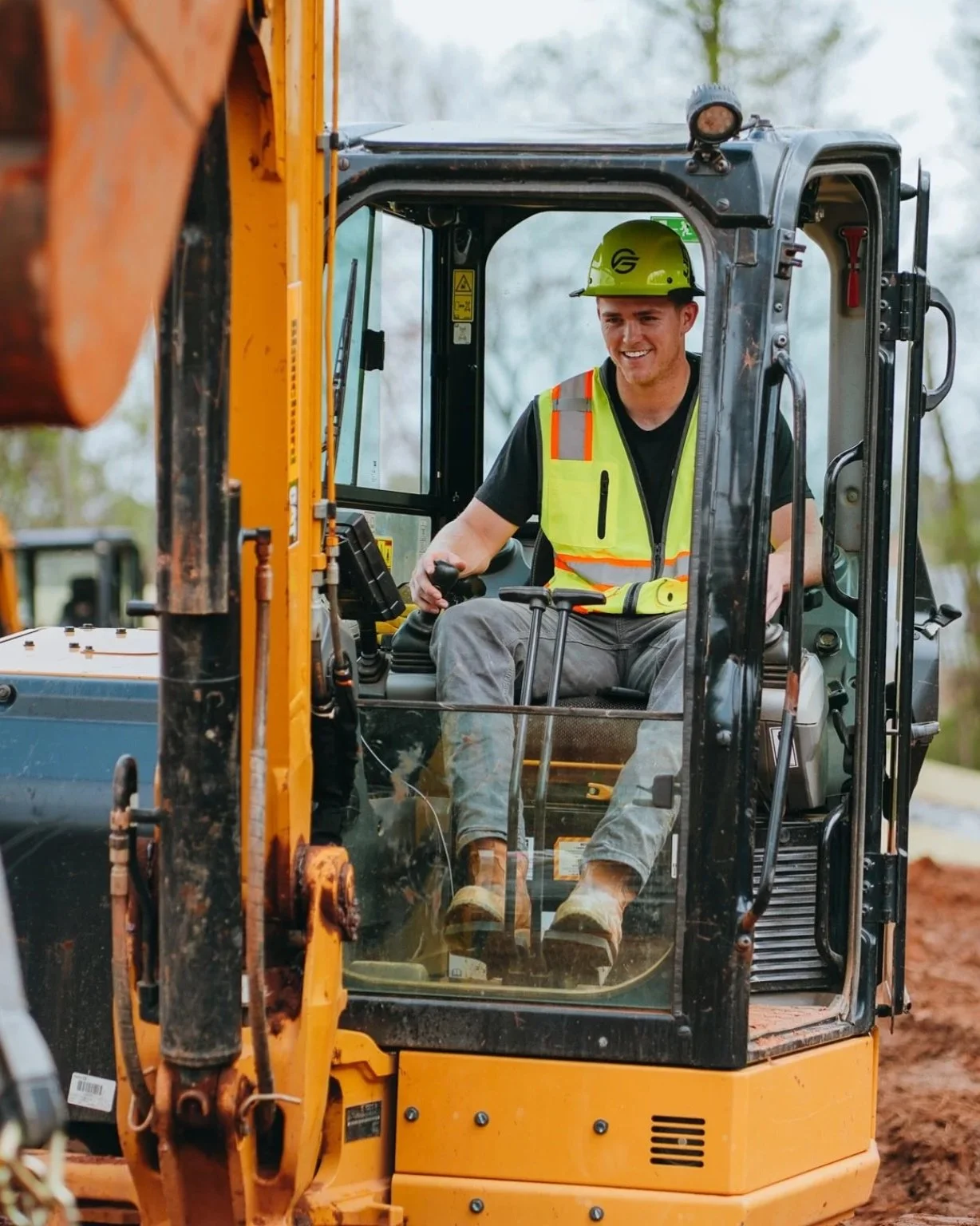 Flush Group equipment operator on excavator during septic system installation