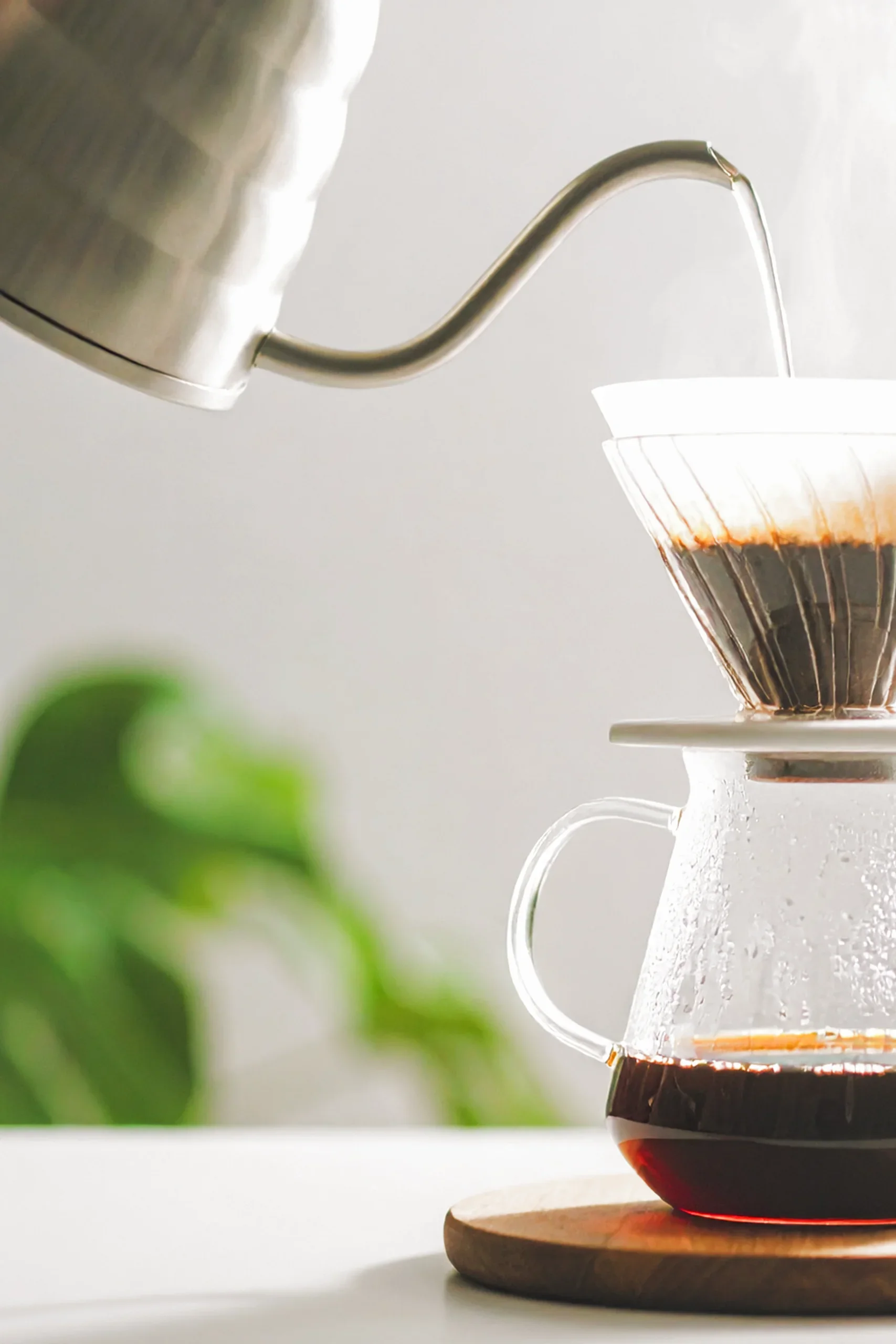 A pour-over coffee being carefully brewed, reflecting the deliberate, craft-driven methodology of Pillar & Press Studio