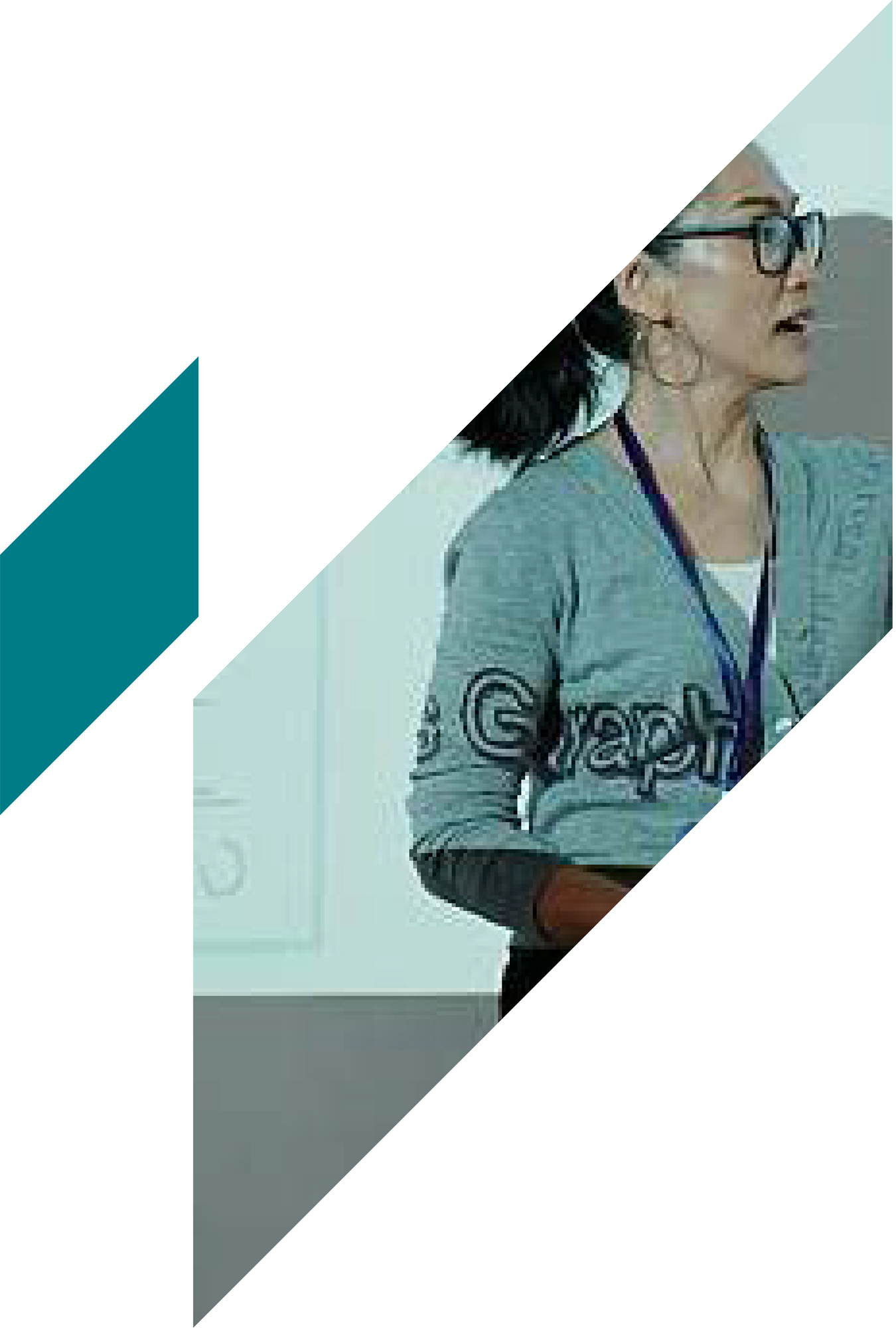 A woman with dark hair, glasses, and earrings, wearing a gray Athletic Works sweatshirt, appears to be speaking or presenting in front of a light-colored wall or screen.