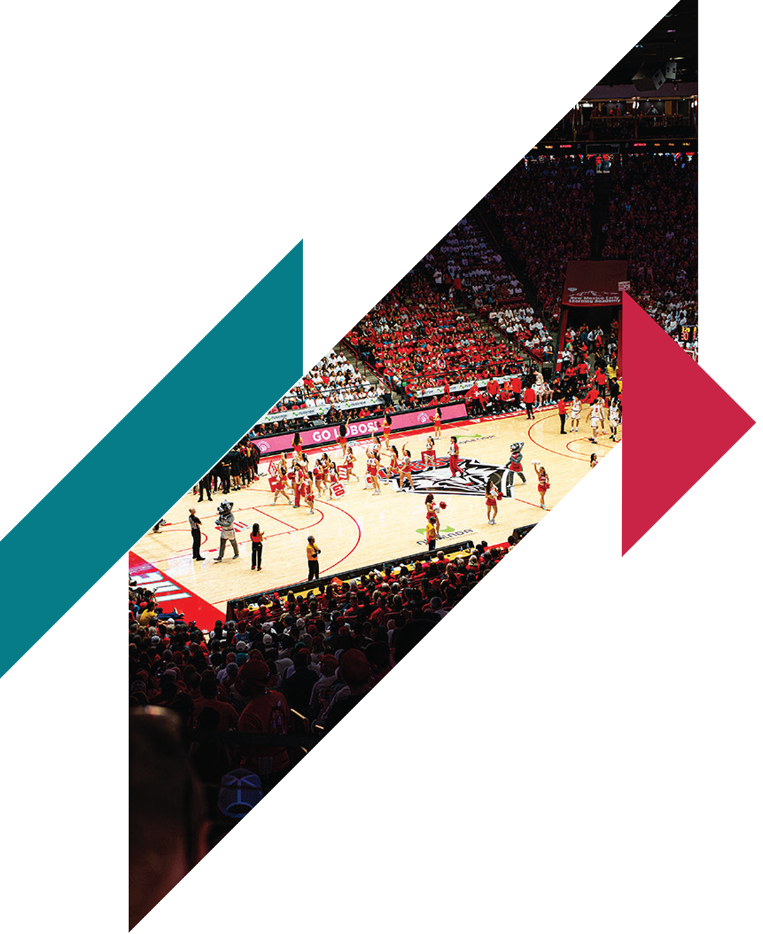 A basketball game in a large arena with players on the court and audience in the stands.