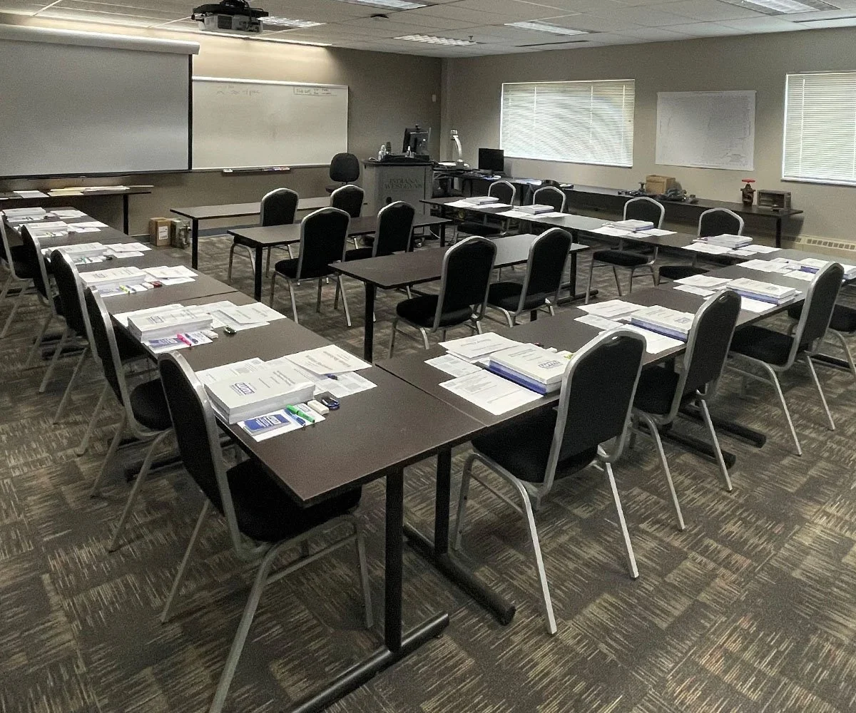 Classroom full of desks, chairs, and papers