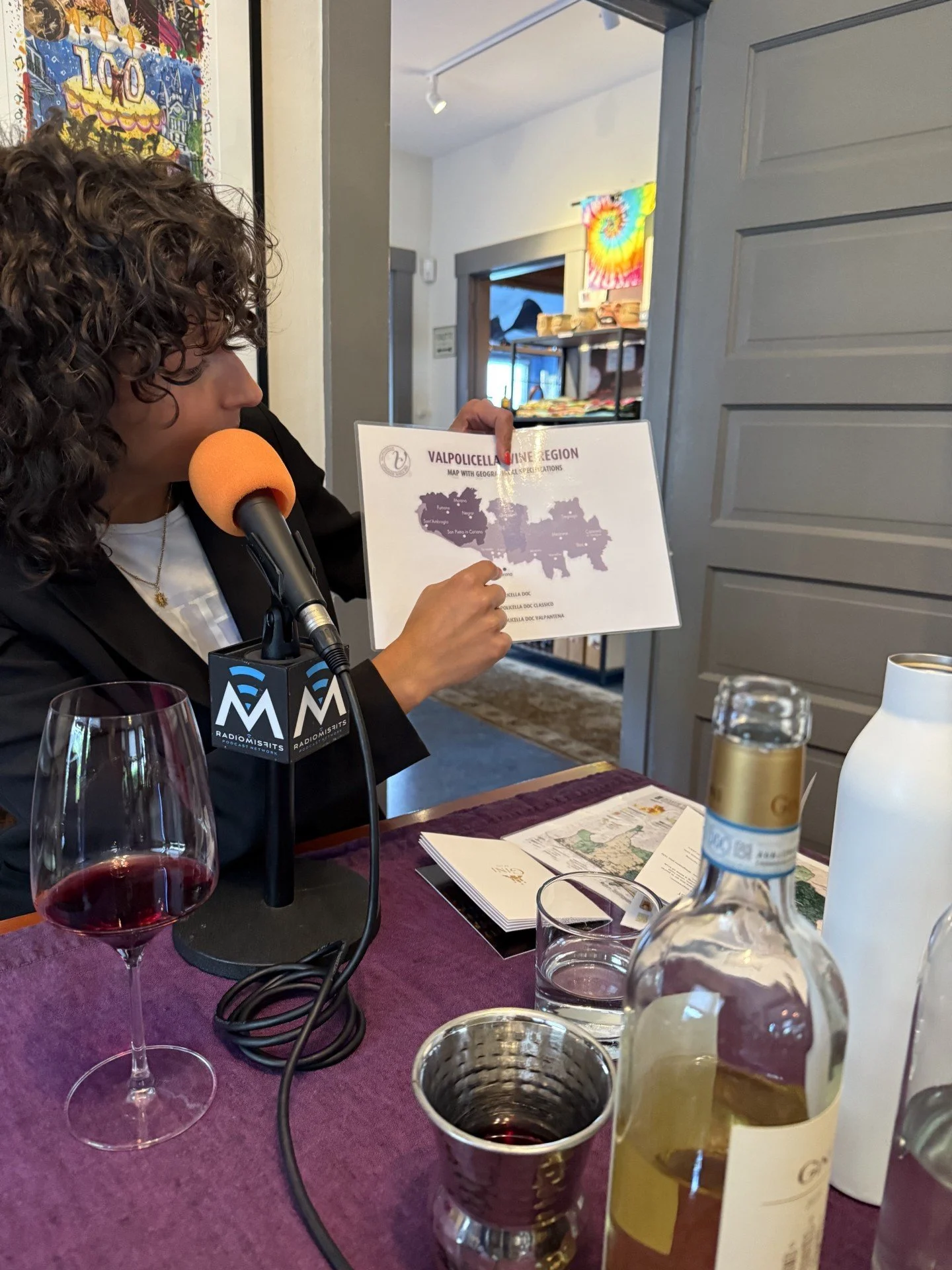 Woman holding map next to wine bottles