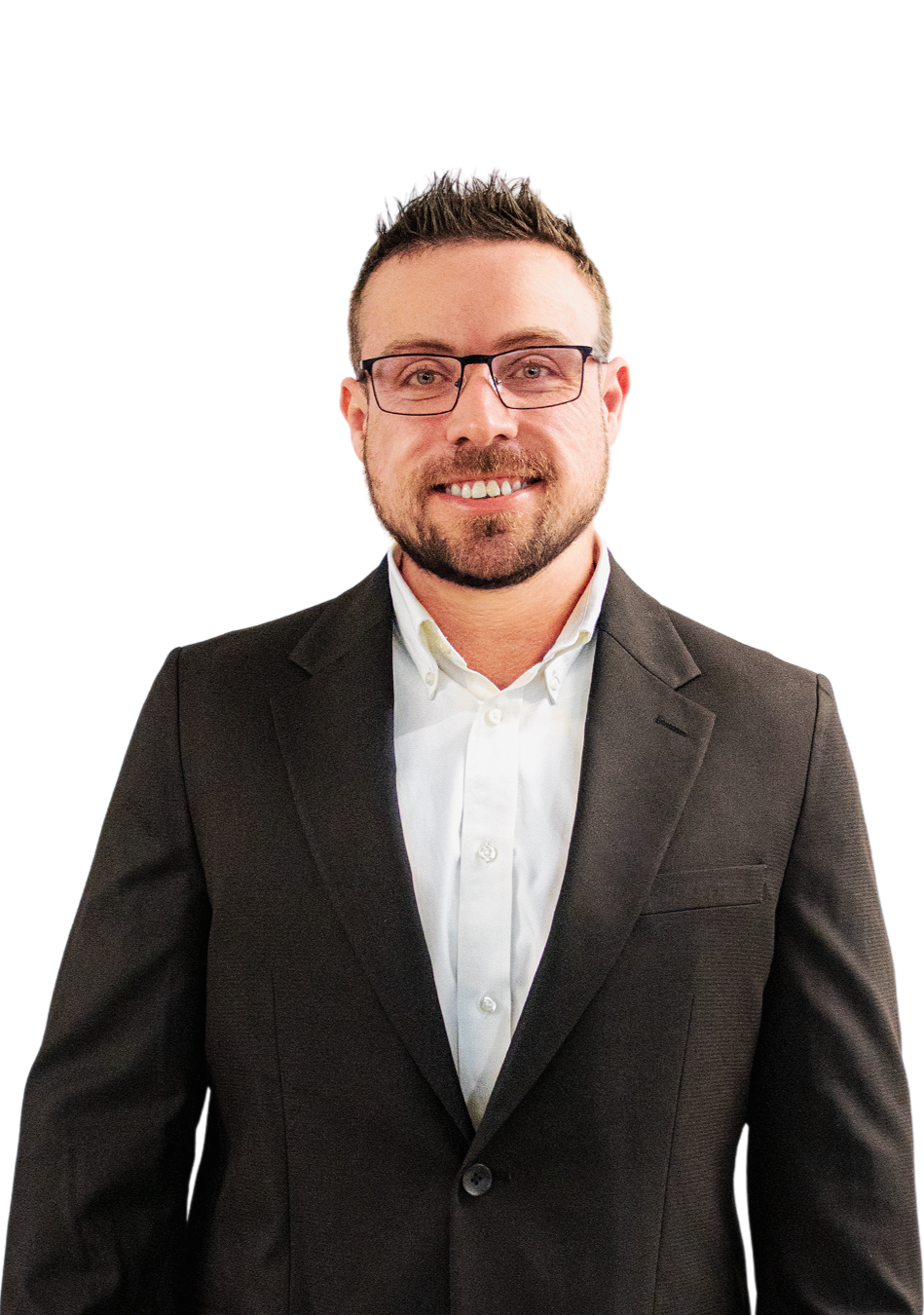 A man with glasses, a beard, and short hair, wearing a black suit and white shirt, smiling at the camera.