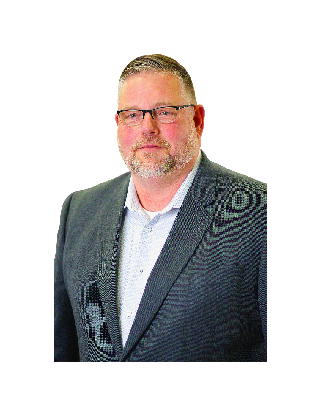 Portrait of a middle-aged man with glasses, a beard, and short hair, wearing a gray suit and white shirt, against a colorful background.