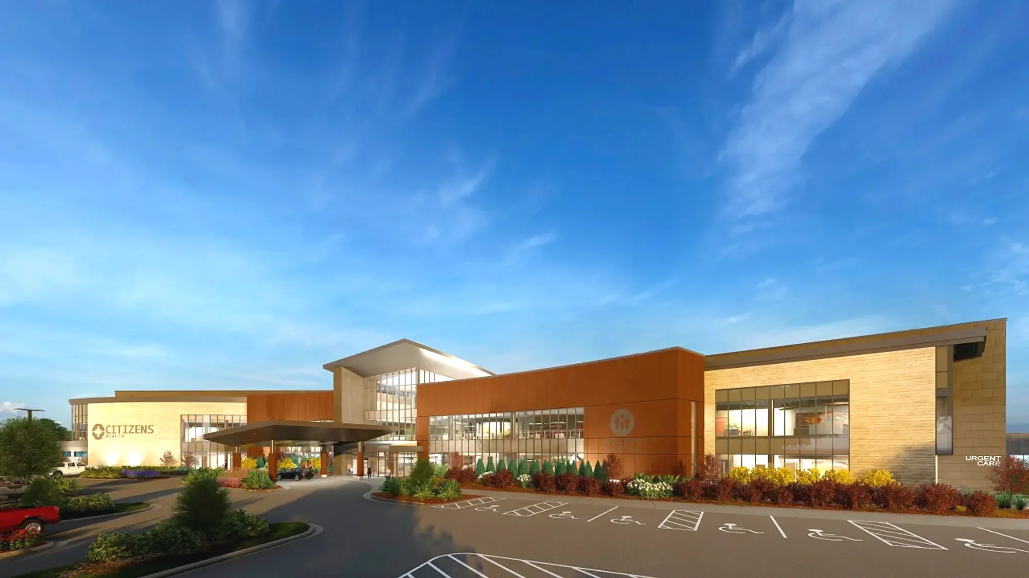Exterior view of a modern medical facility with parking lot, clear sky, and trees. The building has signage that says 'CITIZENS' and 'Urgent Care.'