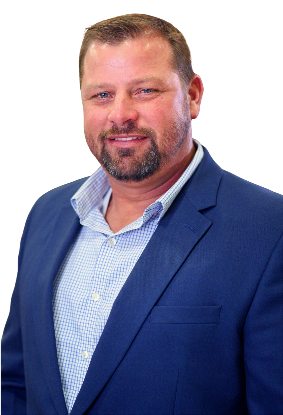A middle-aged man with a beard and short hair, wearing a blue blazer and a blue checkered shirt, smiling at the camera.