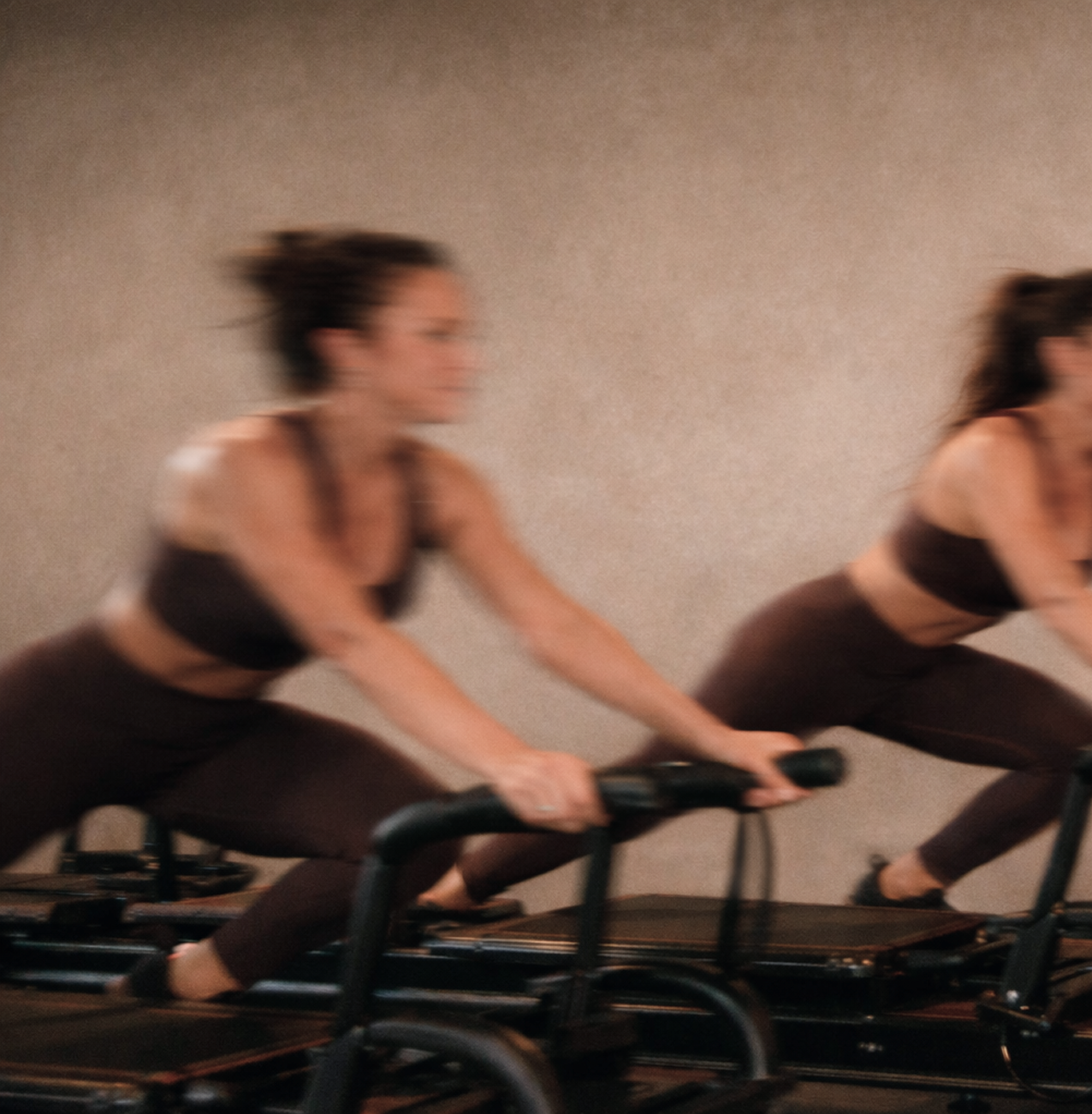 Two women training on Megaformers during a Lagree class at Form Haus in Seaford, NY