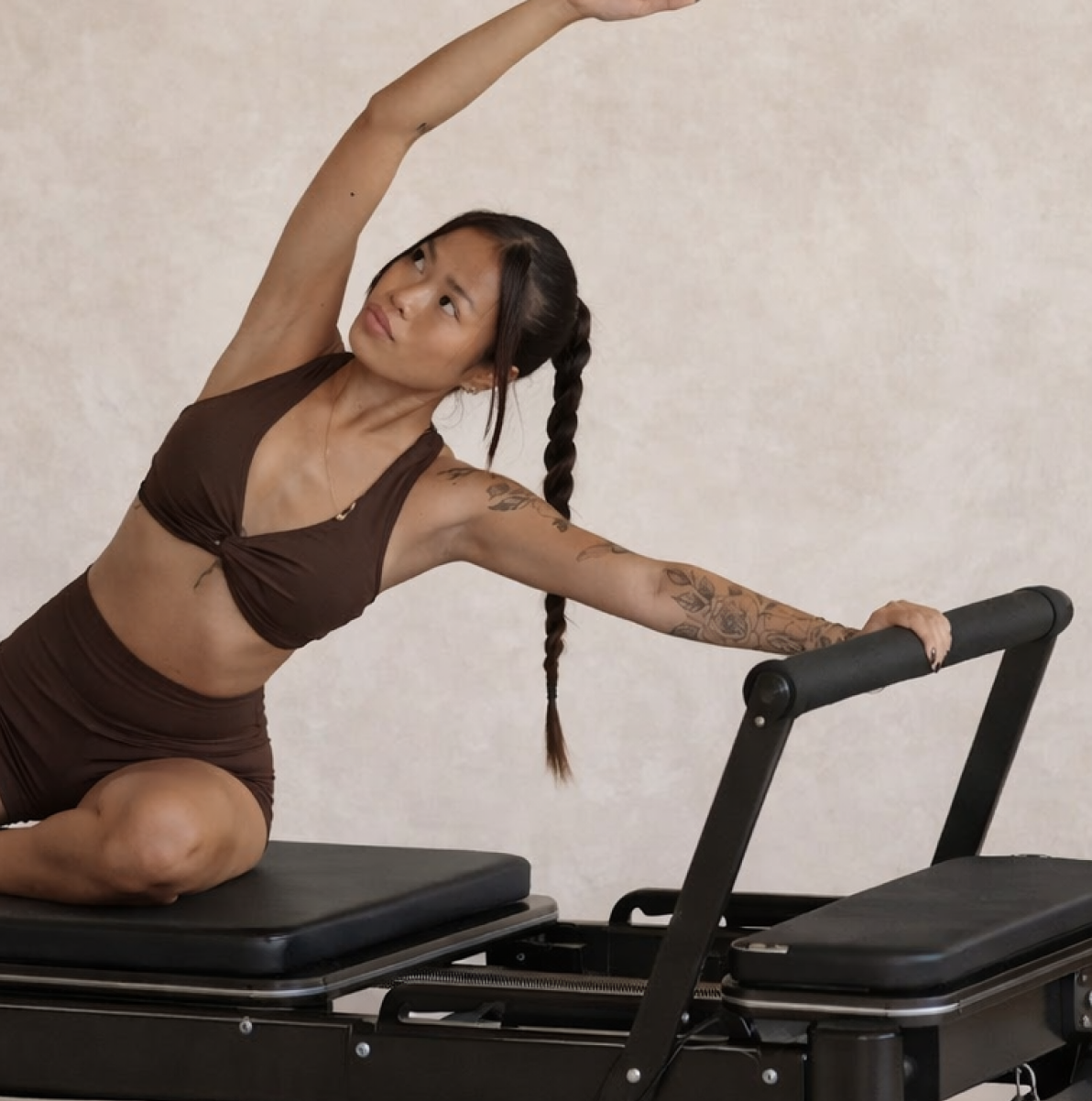 Woman stretching on a Megaformer during a Lagree class at Form Haus in Seaford, NY
