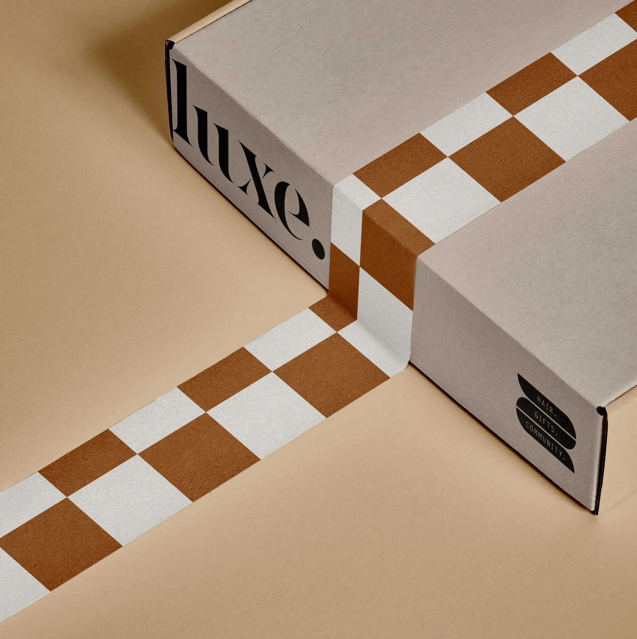 box with luxe logo and checkered tape