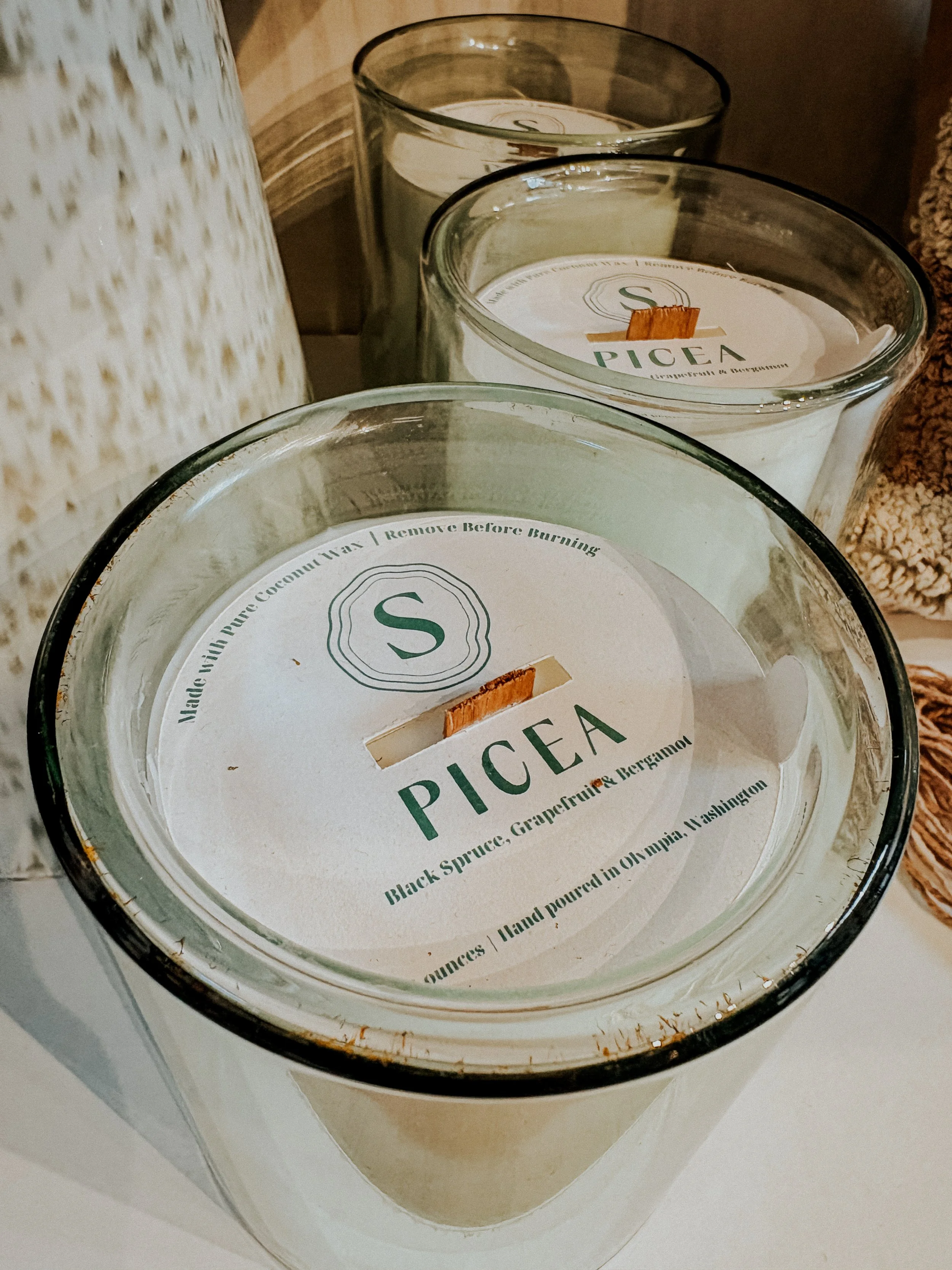 Spruce logo on candle lid packaging