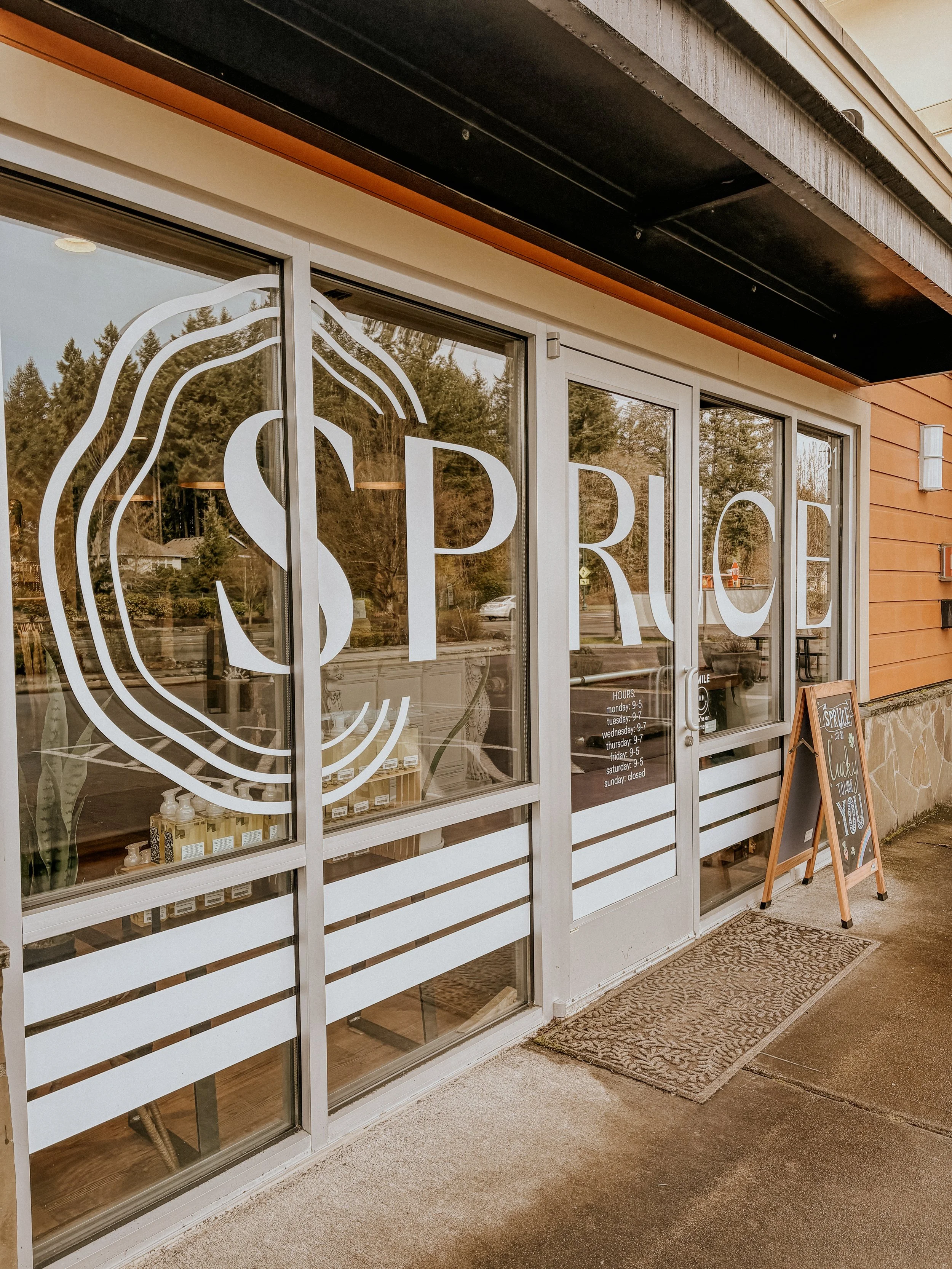 White Spruce logo on entrance of shoppe