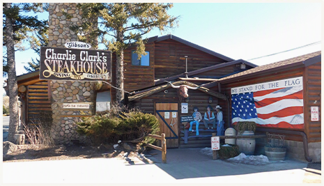 Charlie Clark's Steakhouse log cabin exterior with American flag, Pinetop, Arizona