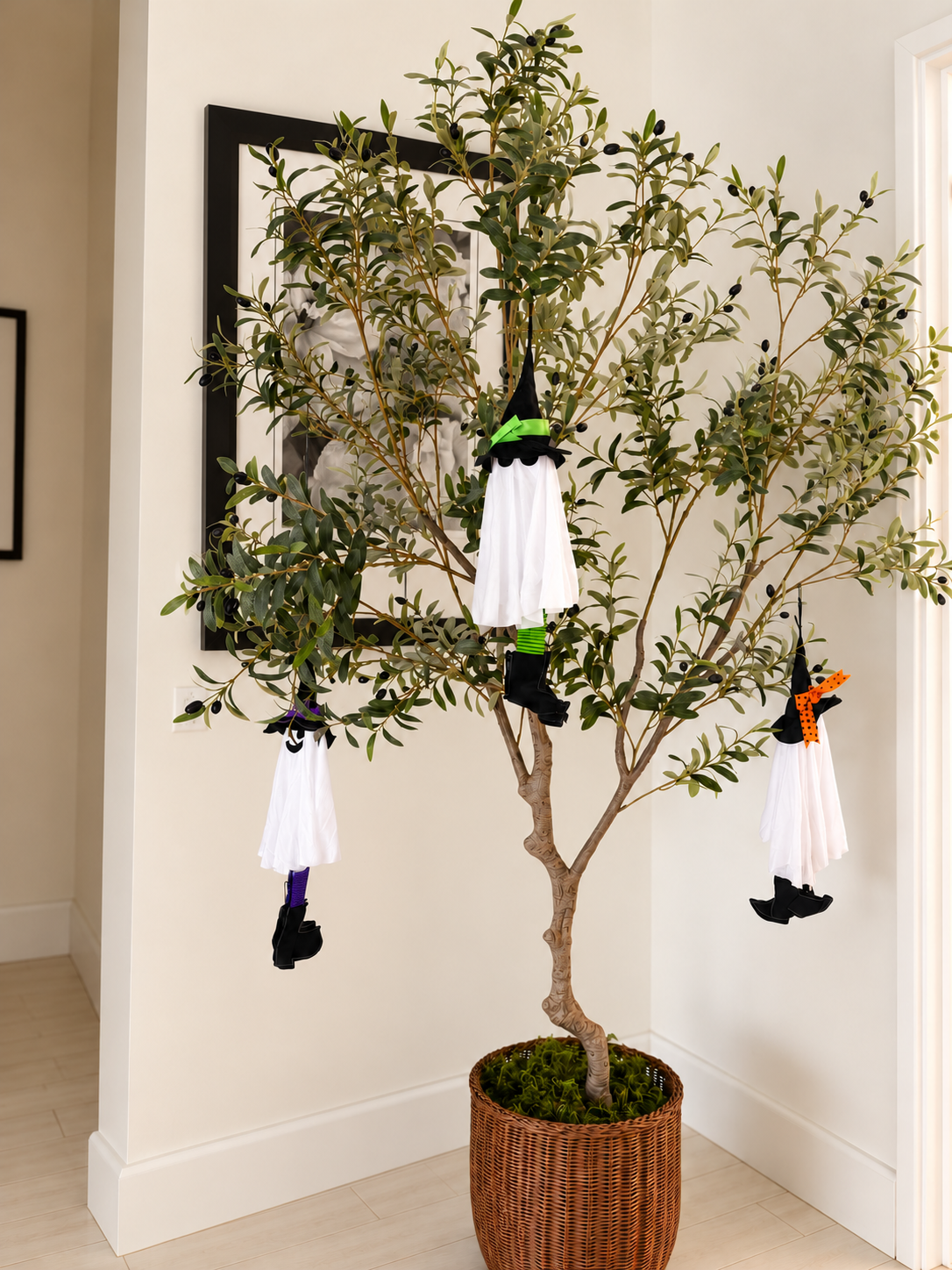 Hanging floral picture behind olive tree.png