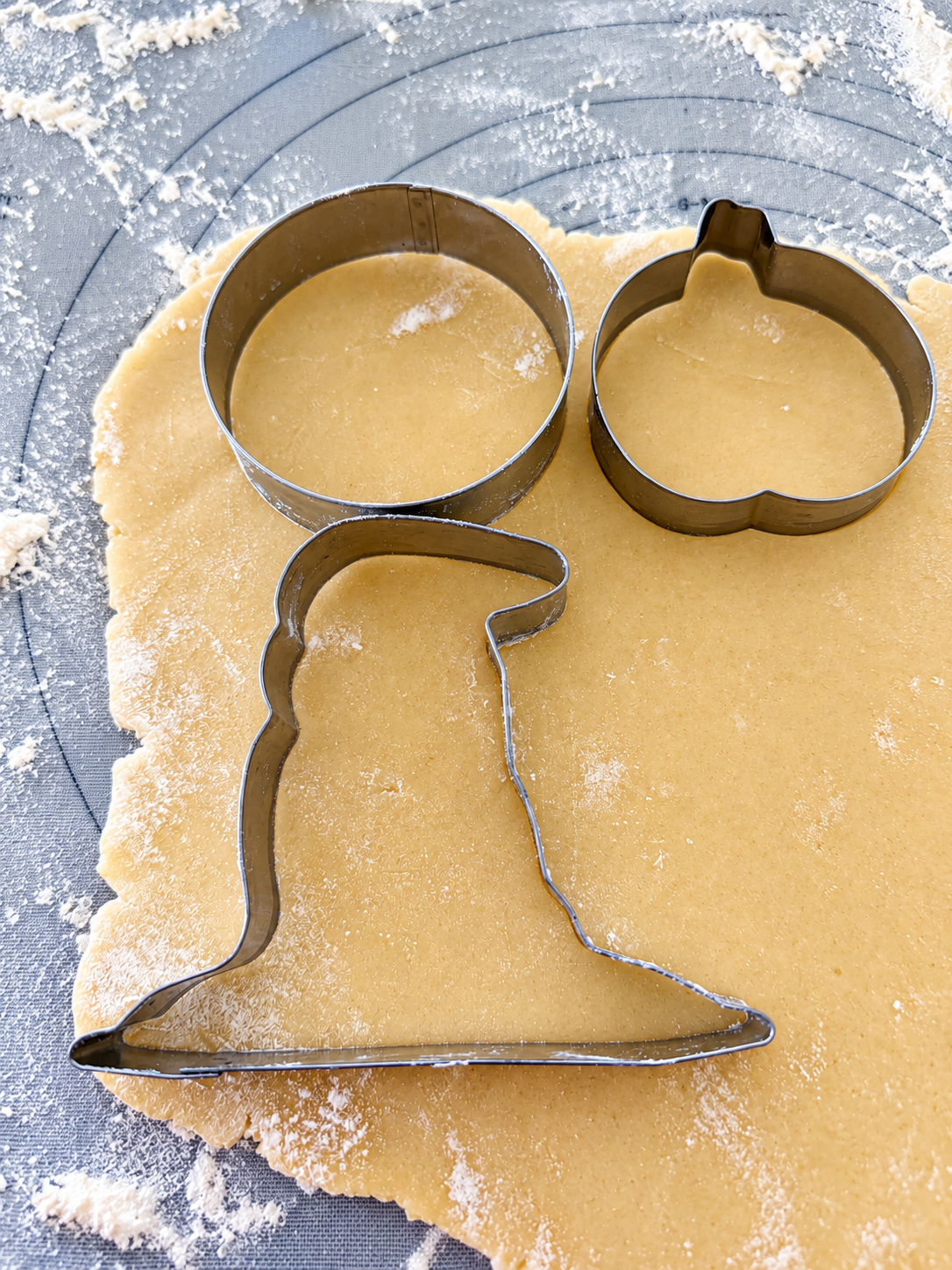 Halloween cookie cutters on rolled dough-1.png