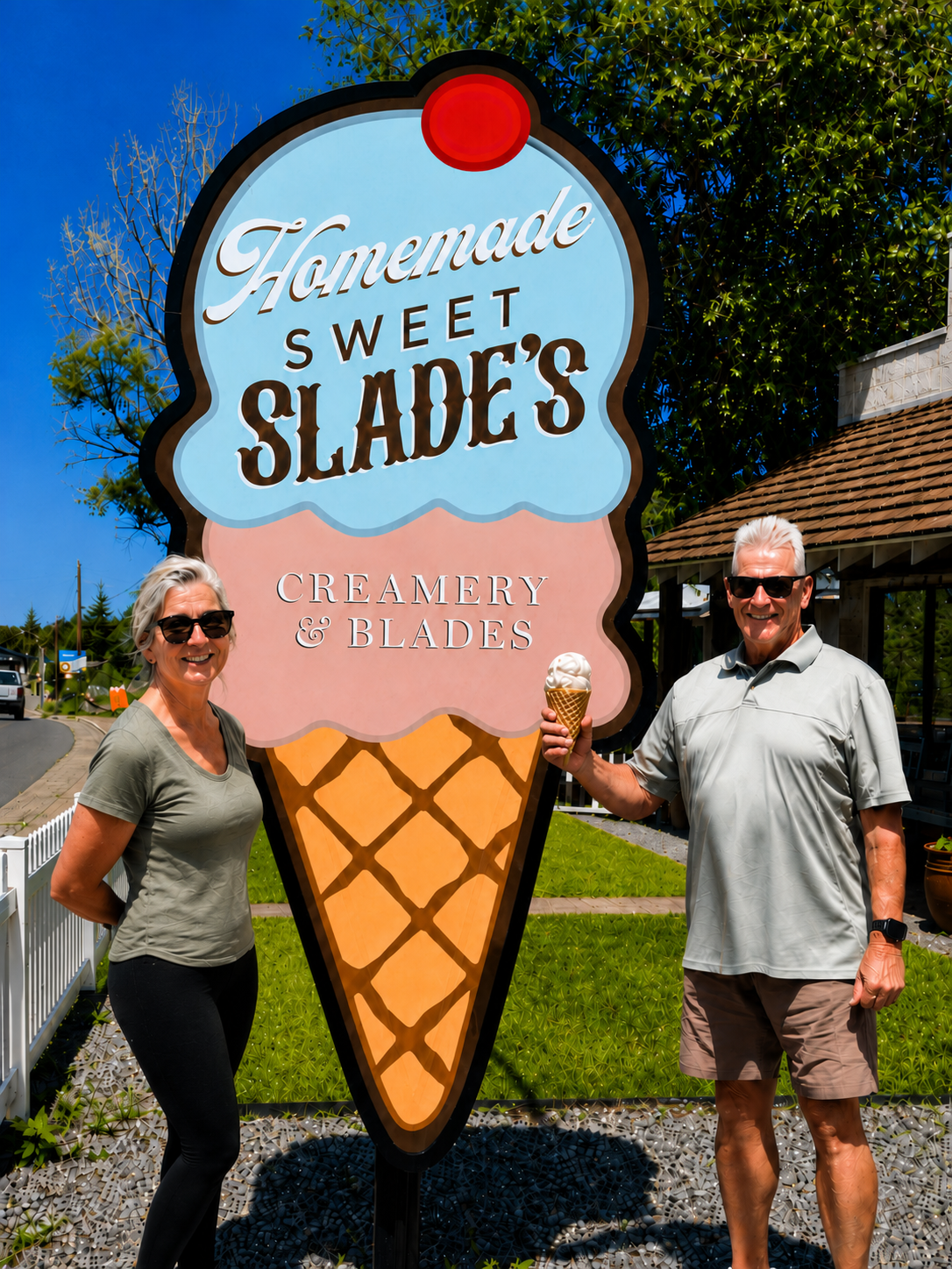 Karen and Johnny B holding ice cream cones in front of the Sweet Slade's Creamery sign in Pinetop, Arizona