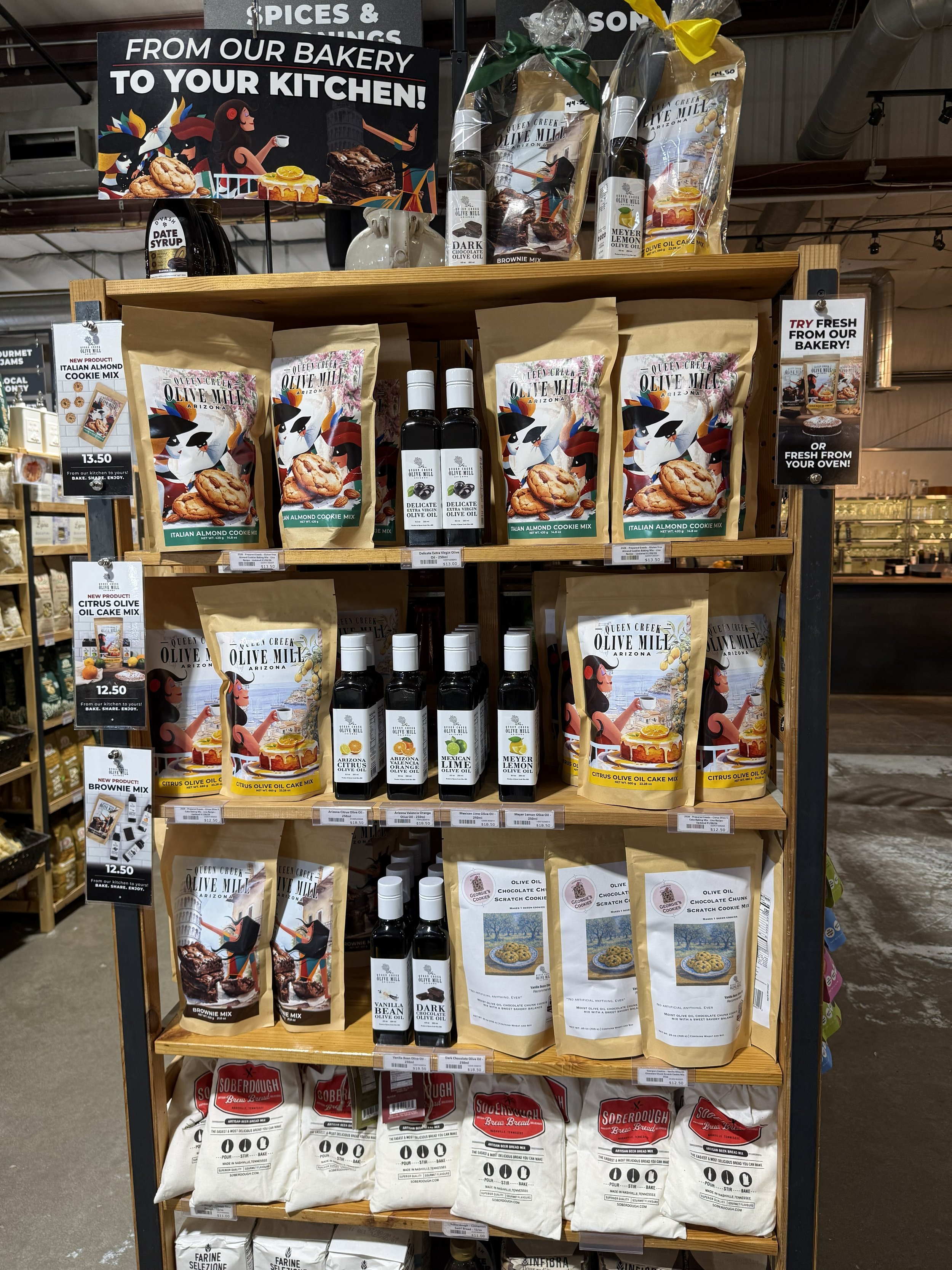 Queen Creek Olive Mill marketplace display filled with olive oils, cookie mixes and olive oil cake mixes.