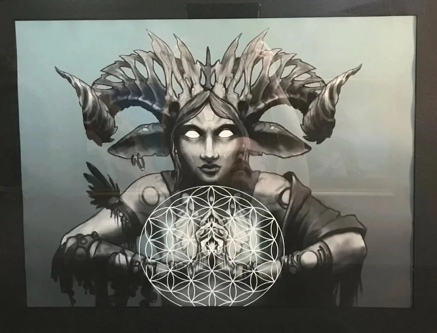 Artistic depiction of a woman with glowing eyes, wearing a headdress made of leaves and horns, holding a geometric pattern resembling a flower of life.