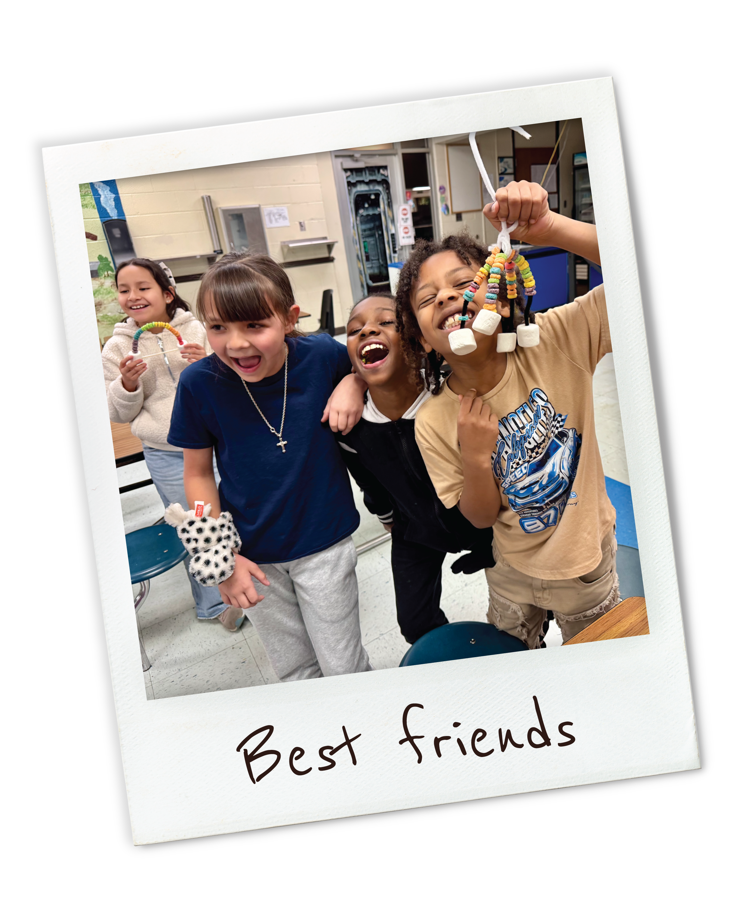A group of children laughing and smiling, holding homemade craft projects, in a classroom setting.