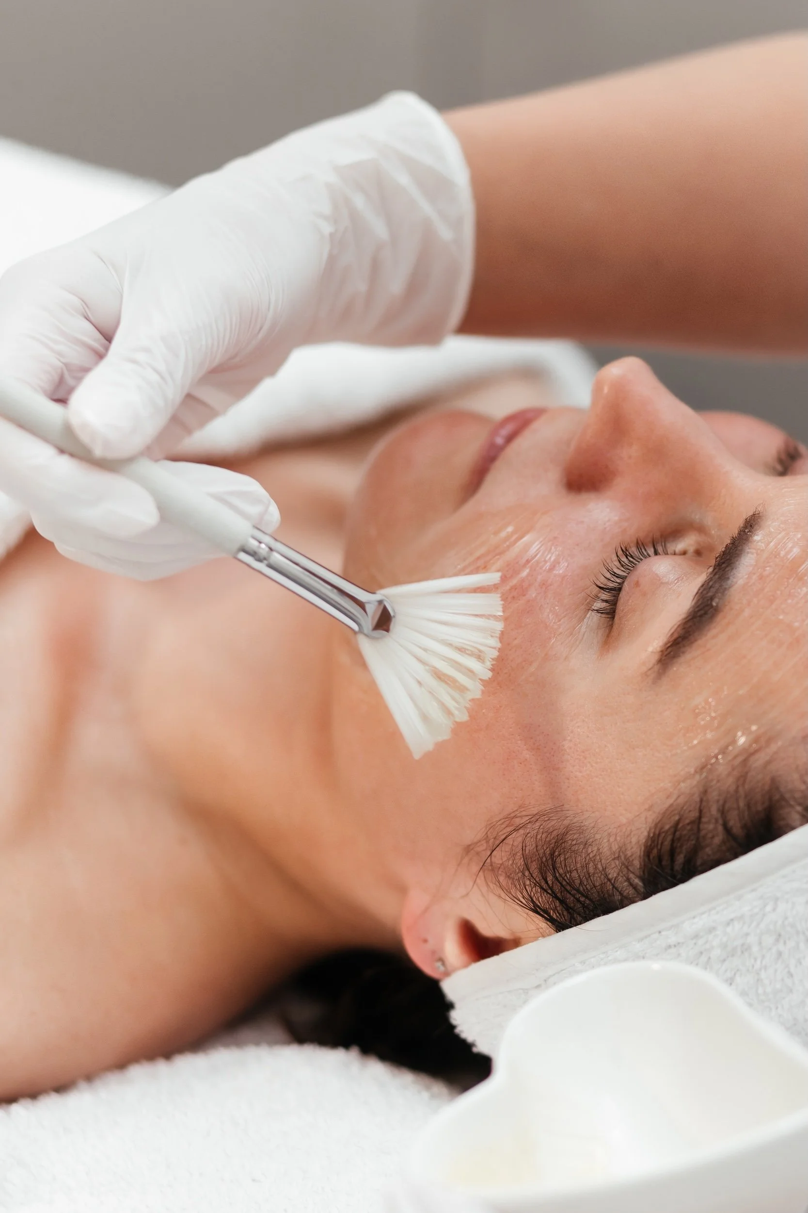 Woman getting a facial treatment in a medspa setting