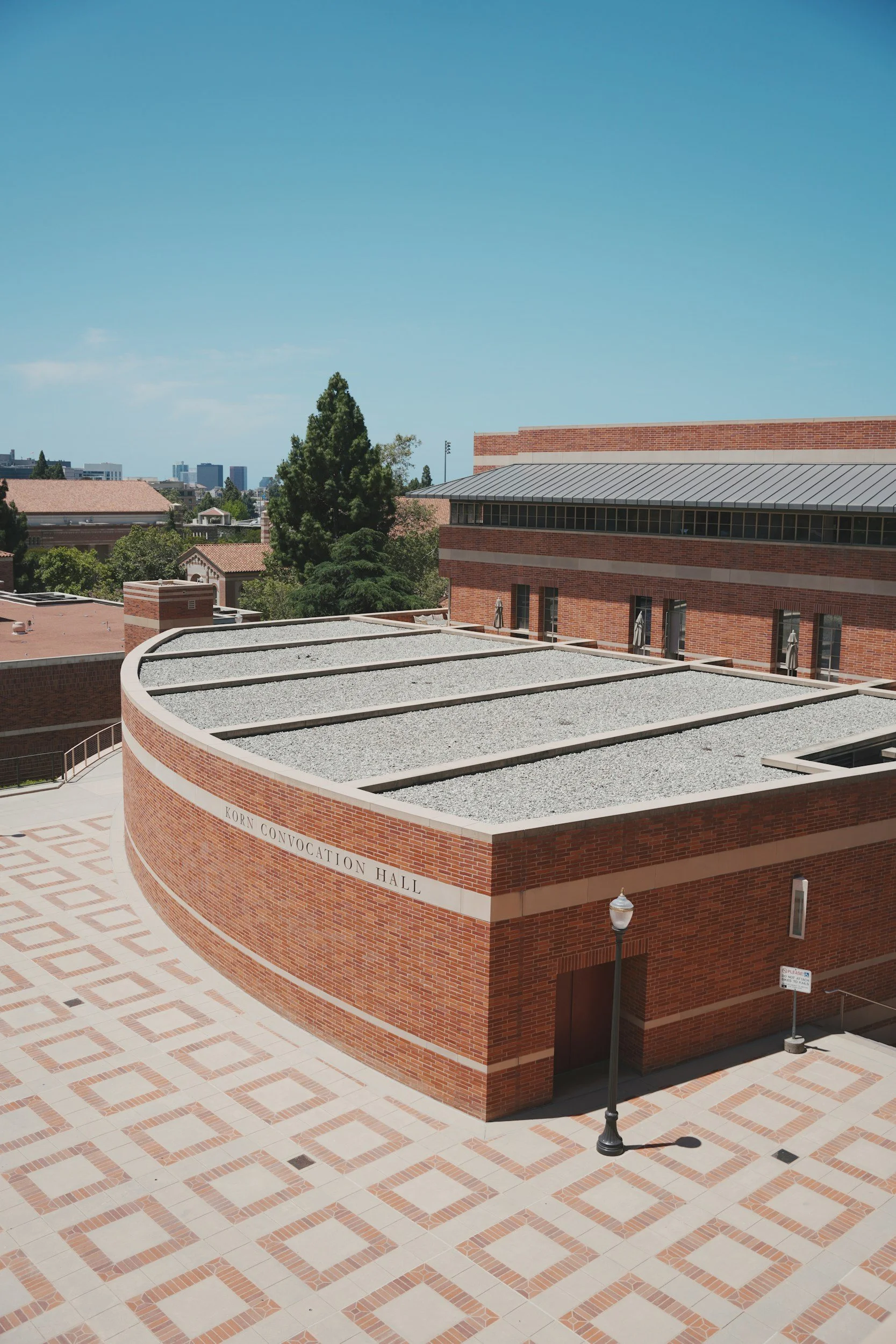 A school building on a bright, sunny Los Angeles university campus – representing the schools and educational spaces where VibeCheckCo provides culture surveys, program evaluations, and professional development in Los Angeles