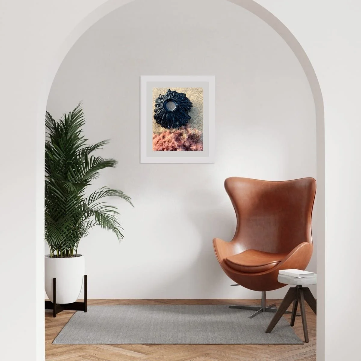 Framed coastal artwork Dark Bloom displayed in a soft, arched interior with a chair and plant, showing scale and placement on a light wall.