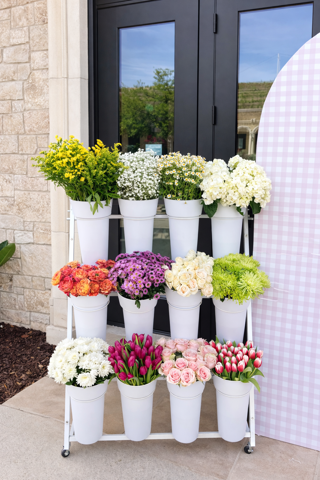 Vibrant flower display by the building.png