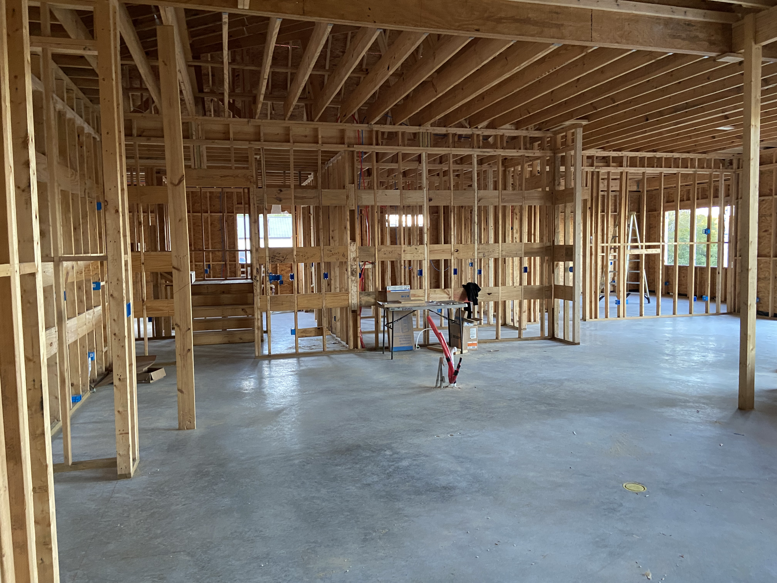 Clean Capricorn Concepts custom home jobsite during the framing and rough-in stage of construction.